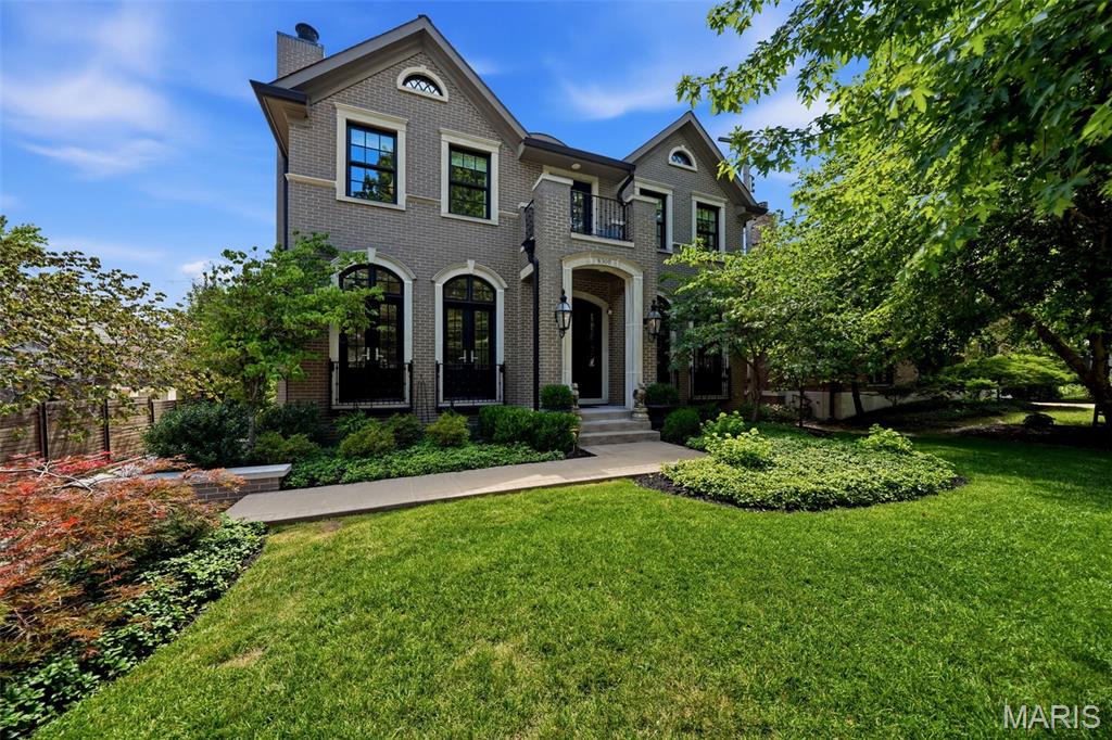Built in 2017, extensively updated, and maintained to the highest standards, this extraordinary residence seamlessly blends timeless architecture with sophisticated modern design in one of Clayton's most coveted locations. From its stately curb appeal to its meticulously curated interiors, every detail reflects uncompromising craftsmanship and enduring quality. Step inside to an immediate sense of openness, where soaring ceilings, walls of windows, and thoughtfully designed living spaces fill the home with natural light and an unmistakable sense of scale.

A grand foyer welcomes you with soaring 10-foot ceilings, rich hardwood flooring that extends throughout the home, and oversized windows that further enhance the home's bright, airy feel. Framing the foyer are two beautifully appointed spaces. To one side, a distinguished study features custom built-ins, elegant French doors, and a dramatic floor-to-ceiling stone fireplace, creating the perfect executive office or intimate sitting room. Opposite, the gracious formal dining room is equally enhanced by French doors, adding architectural character and natural light while providing an elegant setting for entertaining.

At the heart of the home, expansive open living spaces effortlessly connect the kitchen, hearth room, and everyday dining area. Designed for both serious cooks and gracious hosts, the chef's kitchen showcases stunning Crystello quartzite across the oversized waterfall island with prep sink, countertops, backsplash, and adjoining bar, creating a striking, cohesive designer aesthetic. Premium appliances include a Wolf gas range, Sub-Zero refrigerator, dual beverage refrigerators, and a built-in Sub-Zero ice maker. A spacious walk-in pantry and thoughtfully designed butler's bar provide a natural connection to the formal dining room, making entertaining effortless. Just beyond the kitchen, a custom banquette offers generous seating for family and guests, while French doors line the rear of the home, opening to the deck and private outdoor living space for effortless indoor-outdoor entertaining.

The hearth room provides an inviting gathering space, anchored by a floor-to-ceiling stone fireplace that complements the home's timeless palette of natural materials and bespoke finishes.

The upper level offers four spacious en-suite bedrooms, each thoughtfully designed for comfort and privacy. The primary suite is a true retreat, featuring an expansive custom walk-in closet and a spa-inspired bath complete with a freestanding soaking tub, oversized waterfall shower, and curated designer finishes. One of the secondary en-suite bedrooms has been transformed into an exceptional boutique-style dressing room with extensive custom built-ins, offering remarkable flexibility while easily converting back to a traditional bedroom if desired. A conveniently located second-floor laundry room with a utility sink further enhances the home's thoughtful and functional design.

The finished lower level adds exceptional flexibility with ample space for a recreation room, fitness area, or additional family room, along with a convenient powder room, and a locker room just inside the attached two-car garage. An elevator services every level of the home, providing effortless accessibility and everyday convenience.

Perfectly positioned just moments from Shaw Park, award-winning restaurants, boutique shopping, and all that Downtown Clayton has to offer, this remarkable residence presents a rare opportunity to experience exceptional craftsmanship, sophisticated design, and the walkable lifestyle that makes Clayton one of St. Louis' most prestigious communities.