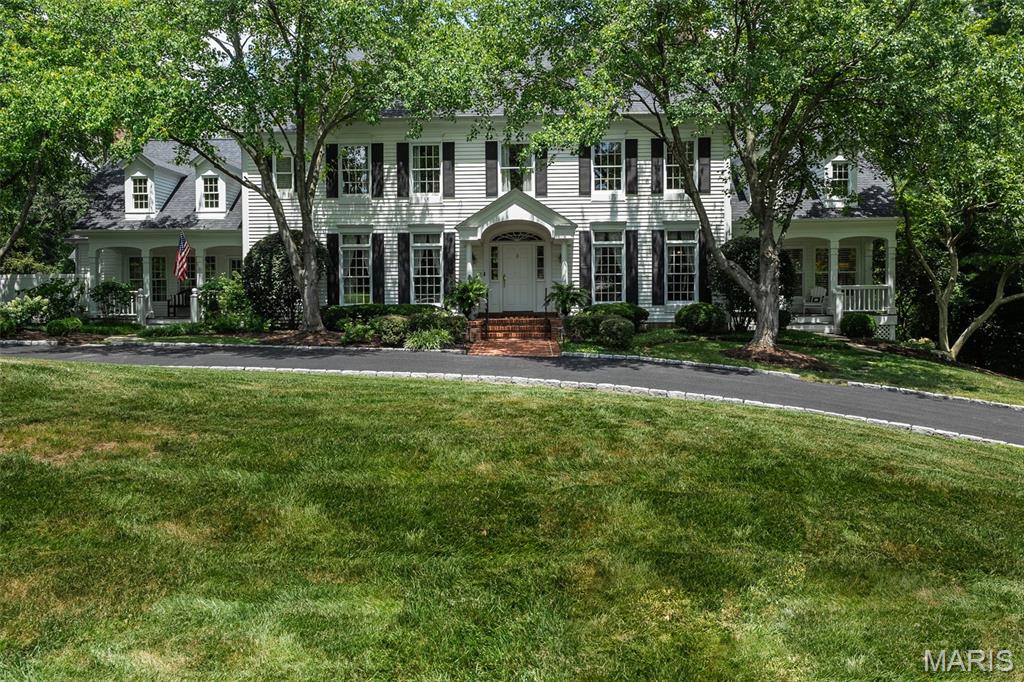 Tucked away on a private street for today's discerning buyer, this stately Colonial-style home offers elegant, functional living space. With 7 bedrooms  there’s room for everyday living and entertaining. The kitchen comfortably seats 7 at the expansive island which opens to eat in dining and hearth room. A screened-in porch, just off the kitchen, provides a peaceful retreat. The elegant dining room and private office with tall ceilings and architectural detail flank the entry. The great room with floor to ceiling windows and coffered ceiling has French doors leading to an idyllic deck overlooking the precisely manicured grounds. Main floor primary suite includes spa like bath and private porch. The lower level offers tall ceilings, 2 additional bedrooms, and walk-out access and vast unfinished space for storage with private work bench room. The resort-style backyard boasts a private pool, outdoor built in cook area, and fire pit. The grounds are enhanced with extensive landscape lighting providing year-round ambiance. Don’t miss this one of a kind retreat like home located in the award-winning Ladue School District.