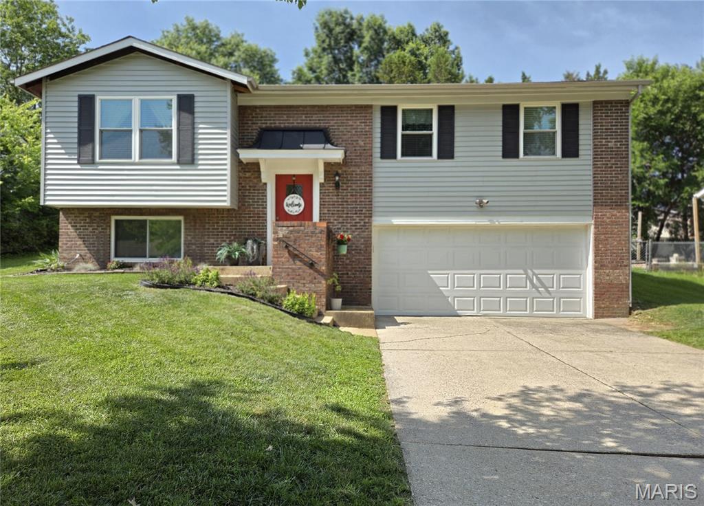 Come see this Adorable Fenton home located in desired Rockwood School District.  A Great opportunity in a Great Location near shopping, schools and major highway. The subdivision offers sidewalks and streetlights perfect for an evening stroll.  This home features 4 bedrooms generous in size and 2 full bathrooms with an oversized 2 car garage.  Other features are fresh paint throughout as well as beautiful hardwood flooring, a spacious dining room and kitchen island coffee bar having extra storage, a Newly Installed mounted microwave, lazy susan cabinet, as well as a kitchen pantry.   Just off the dining room is the backyard entrance just awaiting the new owners touch for a large patio or deck to make it your very own outdoor entertainment space in the Fully Fenced Back Yard.  The lower level 4th bedroom can also be turned into a second living room,  game room, office space OR guest room.  ** New Siding/Shutters 2017, New Windows Throughout 2017, Kitchen Cabinets and Granite Island new in 2017, L/L Ceramic Shower New in 2017, New 6 Panel Doors and Trim 2026, New Main Level Bath dual sink vanity 2024.  Call to get your appointment booked TODAY!!