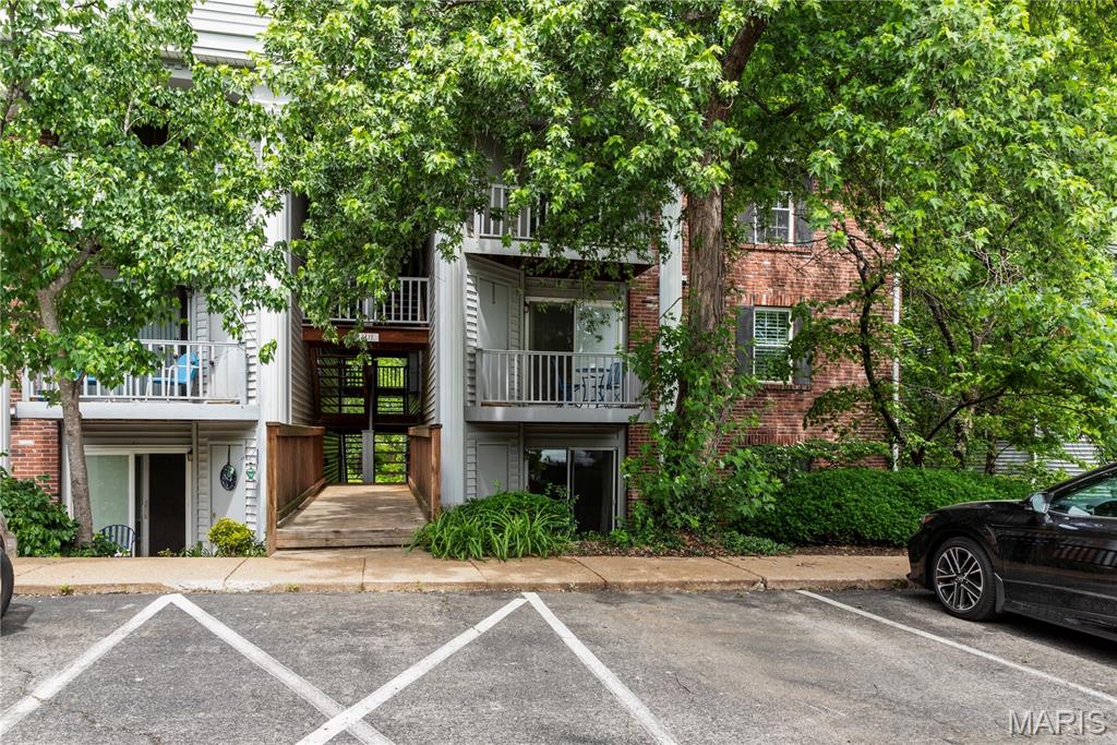 This ground level 2 bed, 2 bath condo sits in the lovely, quiet Kenrick neighborhood of Shrewsbury.  The eat-in kitchen includes soft close cherry cabinets, pantry, appliances and built-in microwave. The spacious living room leads to a walk out front facing patio. It has a more quiet and private cul de sac like location on the far West side of the Trianon complex away from Walmart with no thru traffic, providing particularly quiet mornings and evenings on the patio. The patio provides a large additional storage closet as well. The spacious bedrooms each have large closets with newer 3 panel doors for plenty of storage. Outside you can enjoy a short walk to your nearby car-port and the residents-only pool.  Additionally there's a paved path adjacent to the property leading to Wehner Park for dog walking, running, tennis and playground for kids.  Located between I-44 and Watson Rd with easy access to restaurants and shopping. Property is vacant and the seller is motivated.