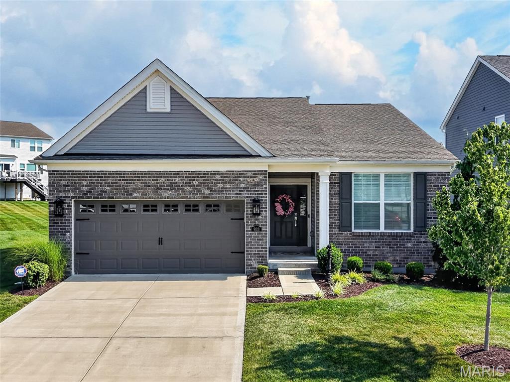 Impressive and beautifully maintained, 3 bedroom, 2 bath, 1,746 sq ft ranch (does not include the Sun Room sq ft) in the sought-after Villages at Sandfort Farm neighborhood!  This lightly lived in ranch home is located in the low maintenance section of the neighborhood where a low monthly fee covers lawn and landscape maintenance and snow removal.  This immaculate home sits in a cul de sac and has excellent curb appeal with brick, vinyl siding, coach lights, architectural shingles, enclosed fascia/soffits, professional landscape and lawn irrigation.  Features include 9 foot ceilings, an on-trend Kitchen, large island with seating bar, quartz countertops, staggered height white cabinets with crown mold and hardware, soft close feature, stainless steel appliances, gas stove with tile backsplash, dishwasher, microwave, touchless faucet, large bowl Kitchen sink, an open floor plan, spacious Great Room, gas fireplace with marble surround, low E windows, large Dining area, secondary bedrooms on the opposite side of the home from the Primary Suite for maximum privacy, main floor laundry room with custom cabinets, Primary Suite with walk in closet, luxury Primary Bath with double bowl raised height vanities, linen towers, marble shower with bench seat, transom window, tall base trim, recessed lighting, ceiling fans and more.  There is a fantastic three-season sunroom with glass from floor to ceiling that opens to a custom patio with landscaped border. One of the secondary bedrooms has a built-in workstation and desk area. The garage is oversized (21’9D) and is insulated, drywalled and fully painted.  The lower level is unfinished but has an egress window and rough in bath for an easy future finish if desired.  Enjoy the neighborhood pool, pavilion, playground, walking trails and easy access to Hwys I-70, 370 and 94/364. There is shopping, restaurants, recreation and services within minutes.  Low maintenance living, beautiful finishes, so much to love!
