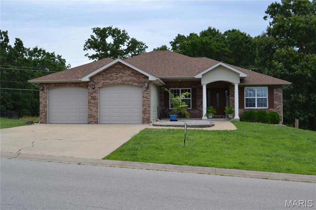 Welcome to this 4 bedroom, 3 bath home located in the Woodridge Subdivision. Step through the front door into an open living room with a gas fireplace, formal dining area or sitting room, an eat-in kitchen with a breakfast bar & nook, stainless steel appliances, and a pantry.  Main level features a primary suite with a jetted tub, separate shower, double vanity, and walk-in closet and 2 other bedrooms, full bath and laundry room. Head down to the fully finished walkout basement that features a massive family room, a recreation room with a bar, barstools, and a mini fridge, a pool table and accessories that stays.  Another bedroom, full bath, a place for an office, and a storm/storage room. Don't forget about the deck that has built in seating. A/C & thermostat new in 2025, New Roof in 2023. New dishwasher 2026. All TV's(4), barstools, mini fridge, pool table and accessories stay. Riding lawnmower and refrigerator in garage also stay. All this and about 10 minutes to everything!!