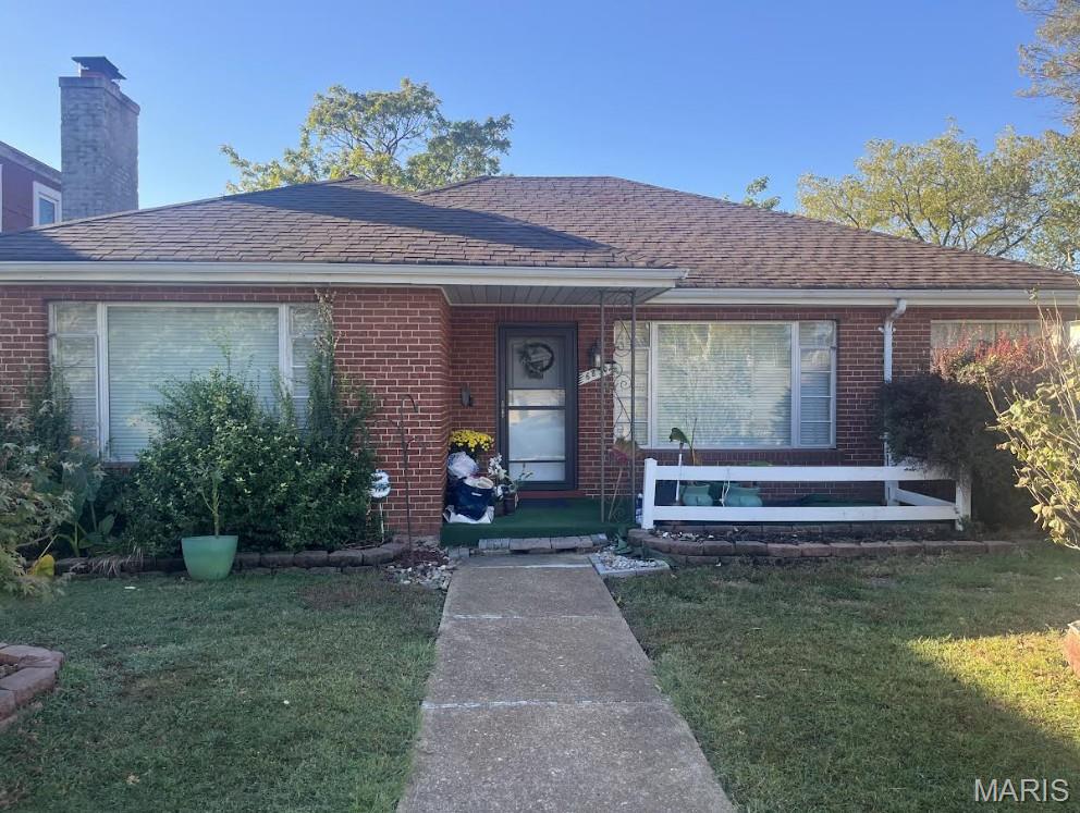 ENDLESS POTENTIAL! This 2-bed, 1.5-bath all-brick home is an ideal canvas for an investor or savvy buyer looking to customize a property in the Franz Park / Dogtown area. Offered in as-is condition, the home features original hardwood flooring and distinctly separate living, dining, and family room areas. A standout feature is the large sunroom, which may serve as a versatile bonus space that could easily become a spectacular year-round home office. For convenience, the drive-under, single-car garage is accessible from the walkout basement. Bring your design ideas and vision! This home is ready for its next chapter!