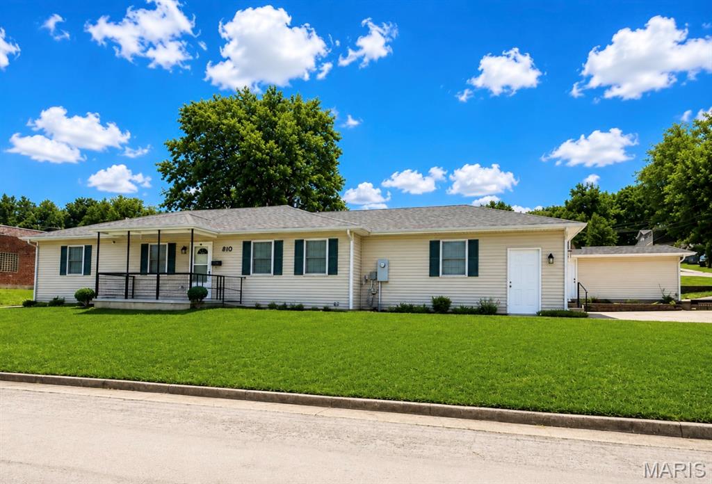 MUST-SEE, WELL-MAINTAINED HOME! This beautifully maintained 1,440 sq. ft. ranch offers a functional floor plan and numerous updates throughout. The spacious kitchen features abundant oak cabinetry, custom tile backsplash, pantry, engineered hardwood flooring, and newer dishwasher, stove, and refrigerator. The adjoining dining area provides direct access to the patio, creating a seamless connection between indoor and outdoor living spaces.  The living room offers ample space for gathering and features an attractive electric fireplace. The primary suite includes a large closet and an updated bath with newer vanity, walk-in jetted tub with custom tile surround, and luxury vinyl plank flooring. Two additional bedrooms offer generous closet space, and the hall bath features a walk-in shower. Additional amenities include engineered hardwood flooring in the kitchen, dining area, laundry room, and hallway, central vacuum system, water softener, and Levolor blinds throughout.  The exceptionally clean crawl space with concrete foundation provides valuable storage space. The oversized side-entry two-car garage is insulated and drywalled, offering flexibility for vehicles, storage, or projects. A large, detached garage provides additional space for vehicles, equipment, hobbies, workshop use, or storage.  The home also features an accessible ramp entrance to the front door. Located in the beautiful historic town of Hermann, this well-cared-for property offers a combination of functionality, storage, and updates that are difficult to find. Conveniently situated near the amenities, attractions, and charm that Hermann is known for, this property is ready for its next owner.