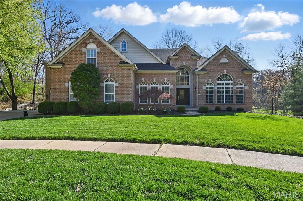 Walk into this gorgeous fully updated 1.5-story home located on a quiet culdesac.  Be immediately impressed by the dramatic two-story entry foyer, soaring ceilings, and expansive window walls that flood the home with natural light while showcasing the picturesque backyard and peaceful wooded views. The formal dining room is conveniently located just off the gourmet kitchen, creating the perfect setting for intimate dinners or larger gatherings.  The kitchen includes high end KitchenAid appliances like the 6-burner gas stove and oven, built in wall oven and microwave combo, 2 sinks, plus granite countertops, custom cabinetry, and a large walk-in pantry.  Three fireplaces throughout the main floor can keep you cozy on the cold winter nights. The main-floor primary suite is a true luxury retreat, with soaring ceilings, a private sitting room, luxury master bath with a free-standing tub, walk in shower and quartz countertops.  Upstairs, you’ll find four generously sized bedrooms, providing ample space for family and guests, along with a wonderful loft area perfect for a playroom, homework zone, or media area. Two full bathrooms serve the upper level, including a thoughtfully designed Jack-and-Jill bathroom. The 4th bedroom is perfect for a bonus/TV room and has a large walk-in closet. The walk-out unfinished basement with lots of windows offers endless potential for future living space ready for your personal vision. Outside, enjoy a serene .5-acre private backyard with a spacious lawn that gently transitions into mature woods. Gather around the fire pit, relax under the stars, and create lasting memories in this peaceful outdoor setting.  Recent updates include newly remodeled maintenance free deck, new front door, new glass sliding back door, whole house humidifier, new roof, gutters and downspouts.  Ideally located near AAA Rockwood schools, shopping, dining, and everyday conveniences. This exceptional home offers the perfect blend of luxury, space, location, and lifestyle.