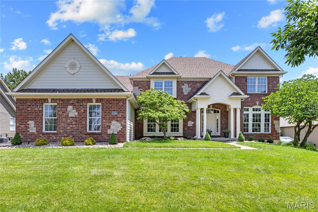 A rare opportunity to own this spectacular brick-and-stone estate in the prestigious gated community of Spring Mill Estates. Offering nearly 7,000 square feet of thoughtfully designed living space, this exceptional Fischer & Frichtel residence blends timeless elegance, superior craftsmanship, and luxurious comfort throughout. A grand foyer with a sweeping flared oak staircase creates a stunning first impression and opens to beautifully appointed living spaces, including an elegant formal dining room, sophisticated study, private home office, and an impressive great room highlighted by soaring ceilings and a dramatic wall of windows that floods the home with natural light. Designed for both everyday living and effortless entertaining, the gourmet kitchen features 42-inch white custom cabinetry, stainless steel appliances, a generous center island, and a butler's pantry. The adjoining breakfast room opens to the inviting four-season room, while the warm and welcoming hearth room showcases a floor-to-ceiling stone fireplace, creating the perfect gathering space. The upper level offers a luxurious primary suite designed as a private retreat, complete with a spa-inspired bath featuring a soaking tub, separate shower, and an adjoining bonus room ideal for a sitting room, nursery, dressing room, or private office. Three additional bedrooms provide exceptional accommodations, including one with a private ensuite bath and two connected by a Jack-and-Jill bath. The finished walk-out lower level is an entertainer's dream, featuring an expansive recreation room, impressive theater room, fitness studio, sleeping area and full bath. Sliding glass doors lead to a resort-style outdoor living area complete with a built-in grilling station, expansive Trex deck, paver patio, and private sport court—offering the perfect backdrop for entertaining, recreation, and relaxing. Every detail of this extraordinary home has been thoughtfully designed to deliver an exceptional lifestyle in one of the area's most sought-after gated communities.