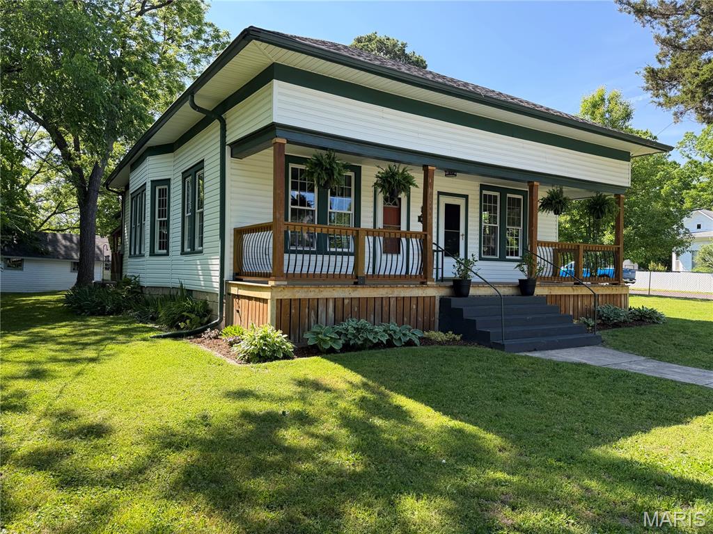Charming and thoughtfully updated 3 bedroom, 1.5 bath bungalow situated on a spacious 92x144 fully chain link fenced lot! Beautiful landscaping surrounds the home with established perennial flowers that bloom year after year, creating wonderful curb appeal. Major improvements include a complete HVAC system with natural gas heat (2021), new architectural shingle roof, repaired sidewalk, and new exterior water lines from city to home (2025). Living room, dining room, and hallway were remodeled to the studs with updated electrical, fresh walls, paint, fixtures, and dimmable can lighting (2022). New flooring installed in living room, dining room, hallway, and 2 bedrooms in 2025. Full of character with high ceilings, oversized windows for abundant natural light, wide hallway, cozy reading nook, and partial basement area. Spacious kitchen offers refrigerator, dishwasher, and large pantry. Enjoy relaxing on the covered front porch or entertain guests on the covered back deck. Storage shed provides excellent space for lawn equipment, gardening tools, and extra storage. Move-in ready and full of charm—schedule your private showing today!