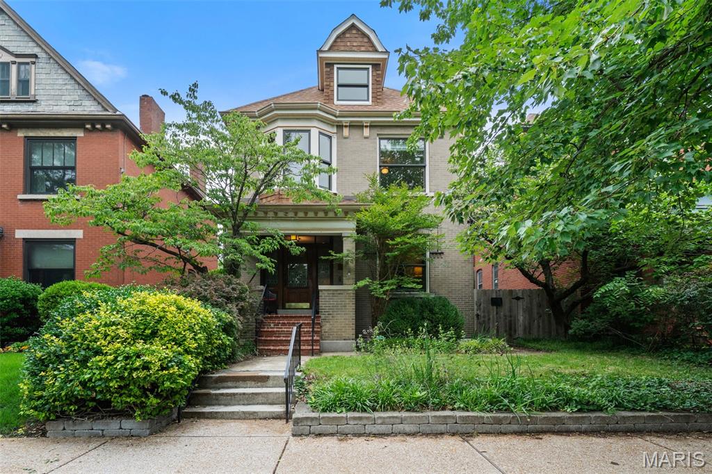 Located just one block from Tower Grove Park and one block from the vibrant South Grand Business District, this beautifully maintained historic home offers the perfect blend of timeless character and thoughtful modern updates in the heart of Tower Grove South. Inside, rich original hardwood floors, dual stained wood trim, box-beamed ceilings, and functional pocket doors showcase the craftsmanship and charm that make historic city homes so special. The inviting living spaces are filled with warmth and character, anchored by a gas fireplace that creates a comfortable focal point for everyday living and entertaining. The updated eat-in kitchen features brand-new granite countertops (2026), and direct access to a spacious screened-in porch overlooking the landscaped backyard—creating the ideal setup for morning coffee, outdoor dining, or relaxing evenings at home. A newly added main-floor half bath (2025) enhances convenience and functionality. Upstairs, generous bedroom spaces provide flexibility for family, guests, or home office needs, while the layout still offers potential for a future primary suite expansion if desired. Zoned HVAC provides added comfort and efficiency throughout the home. Outdoor living is equally impressive with a beautifully landscaped rear yard, screened porch, and convenient 2-car parking pad. With unbeatable walkability to Tower Grove Park, restaurants, coffee shops, nightlife, and neighborhood favorites, this is a rare opportunity to enjoy classic St. Louis architecture paired with modern livability in one of the city’s most sought-after neighborhoods.