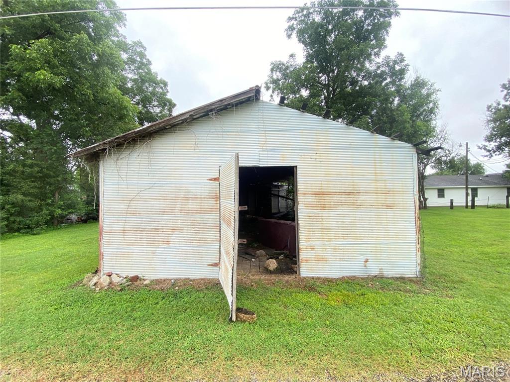 Located at 1 E. Howard Street, Malden, MO, just behind the church, this versatile property offers endless potential in the heart of town. Situated on a small lot, the property features a durable metal building with a metal roof and a secure entry door. Inside, you’ll find a spacious open-concept layout ready to be customized to fit your needs. Whether you’re looking for a workshop, storage space, retail, office, or your next investment opportunity, the possibilities are endless. Conveniently located with easy access to local amenities, this property is ready for your vision to become reality.