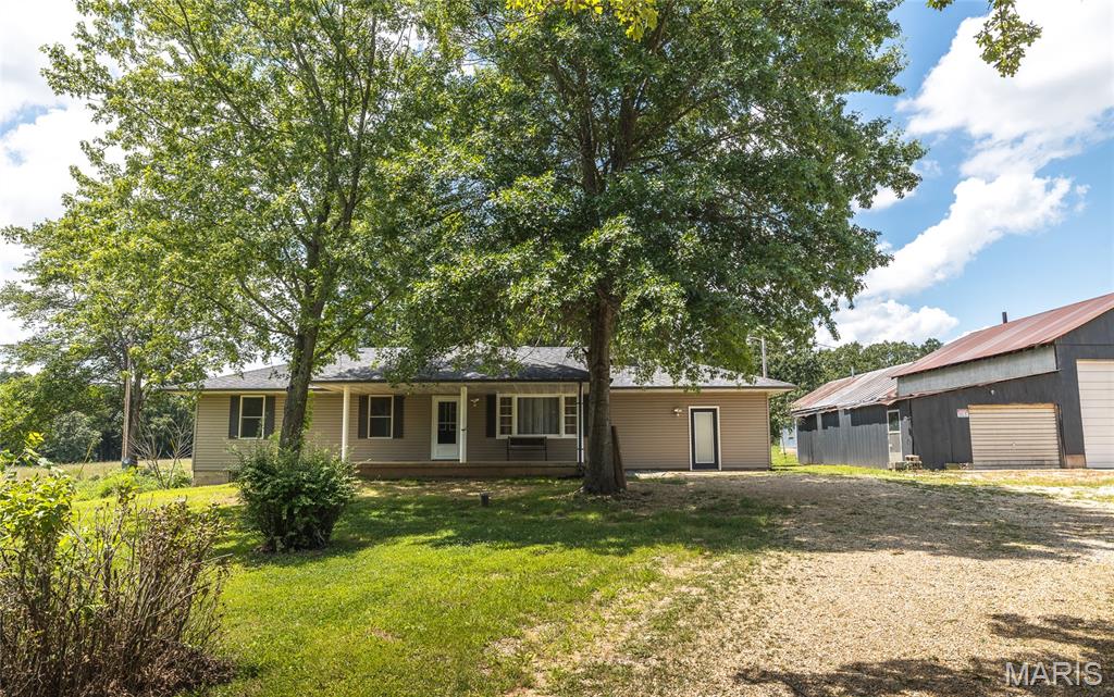 HOME HAS APPRAISED AT ASKING PRICE AND SELLER HAS A HOME INSPECTION!! Escape to the peace and privacy of rural Missouri with this beautifully updated 5-bedroom, 3-bath home nestled on nearly 15 acres of a perfect blend of open ground and wooded landscape. Backing up to the Little Prairie Conservation Area, this property offers a rare opportunity to enjoy nature, wildlife, and wide-open space right in your own backyard. Inside, the home has been thoughtfully upgraded to combine modern comfort with timeless style. The kitchen is a true centerpiece, featuring soft-close Shaker cabinets, quartz countertops, a fireclay undermount sink, stainless steel appliances, and a functional island cooktop—ideal for gathering and entertaining. Recessed lighting and fresh interior finishes create a bright, welcoming atmosphere throughout. The living room invites you to unwind by the wood-burning fireplace with insert, while the spacious layout provides room for everyone. Bathrooms have been tastefully updated with tile flooring and Bluetooth exhaust fans, and the walk-in Jacuzzi tub offers a spa-like retreat. The finished walk-up basement expands your living space with a family room, additional bedroom, and bathroom—perfect for guests or multi-generational living. Step outside and experience everything this property has to offer—from the stocked pond and fenced areas to the barn, chicken coop, and detached shop building ready for hobbies or storage. A brand-new septic system and new privacy fence add even more value and peace of mind. With a drilled well, lagoon, and major system updates already in place, this property is ready for you to enjoy. If you’ve been dreaming of space, privacy, and a true country lifestyle, this is it—schedule your private showing today!