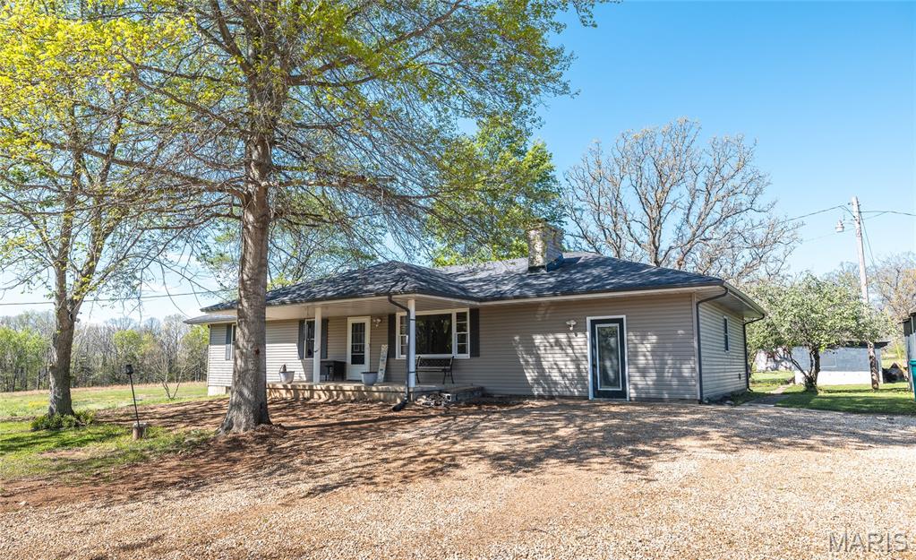 HOME HAS APPRAISED AT ASKING PRICE AND SELLER HAS A HOME INSPECTION!! Escape to the peace and privacy of rural Missouri with this beautifully updated 5-bedroom, 3-bath home nestled on nearly 15 acres of a perfect blend of open ground and wooded landscape. Backing up to the Little Prairie Conservation Area, this property offers a rare opportunity to enjoy nature, wildlife, and wide-open space right in your own backyard. Inside, the home has been thoughtfully upgraded to combine modern comfort with timeless style. The kitchen is a true centerpiece, featuring soft-close Shaker cabinets, quartz countertops, a fireclay undermount sink, stainless steel appliances, and a functional island cooktop—ideal for gathering and entertaining. Recessed lighting and fresh interior finishes create a bright, welcoming atmosphere throughout. The living room invites you to unwind by the wood-burning fireplace with insert, while the spacious layout provides room for everyone. Bathrooms have been tastefully updated with tile flooring and Bluetooth exhaust fans, and the walk-in Jacuzzi tub offers a spa-like retreat. The finished walk-up basement expands your living space with a family room, additional bedroom, and bathroom—perfect for guests or multi-generational living. Step outside and experience everything this property has to offer—from the stocked pond and fenced areas to the barn, chicken coop, and detached shop building ready for hobbies or storage. A brand-new septic system and new privacy fence add even more value and peace of mind. With a drilled well, lagoon, and major system updates already in place, this property is ready for you to enjoy. If you’ve been dreaming of space, privacy, and a true country lifestyle, this is it—schedule your private showing today!