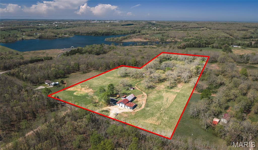 HOME HAS APPRAISED AT ASKING PRICE AND SELLER HAS A HOME INSPECTION!! Escape to the peace and privacy of rural Missouri with this beautifully updated 5-bedroom, 3-bath home nestled on nearly 15 acres of a perfect blend of open ground and wooded landscape. Backing up to the Little Prairie Conservation Area, this property offers a rare opportunity to enjoy nature, wildlife, and wide-open space right in your own backyard. Inside, the home has been thoughtfully upgraded to combine modern comfort with timeless style. The kitchen is a true centerpiece, featuring soft-close Shaker cabinets, quartz countertops, a fireclay undermount sink, stainless steel appliances, and a functional island cooktop—ideal for gathering and entertaining. Recessed lighting and fresh interior finishes create a bright, welcoming atmosphere throughout. The living room invites you to unwind by the wood-burning fireplace with insert, while the spacious layout provides room for everyone. Bathrooms have been tastefully updated with tile flooring and Bluetooth exhaust fans, and the walk-in Jacuzzi tub offers a spa-like retreat. The finished walk-up basement expands your living space with a family room, additional bedroom, and bathroom—perfect for guests or multi-generational living. Step outside and experience everything this property has to offer—from the stocked pond and fenced areas to the barn, chicken coop, and detached shop building ready for hobbies or storage. A brand-new septic system and new privacy fence add even more value and peace of mind. With a drilled well, lagoon, and major system updates already in place, this property is ready for you to enjoy. If you’ve been dreaming of space, privacy, and a true country lifestyle, this is it—schedule your private showing today!