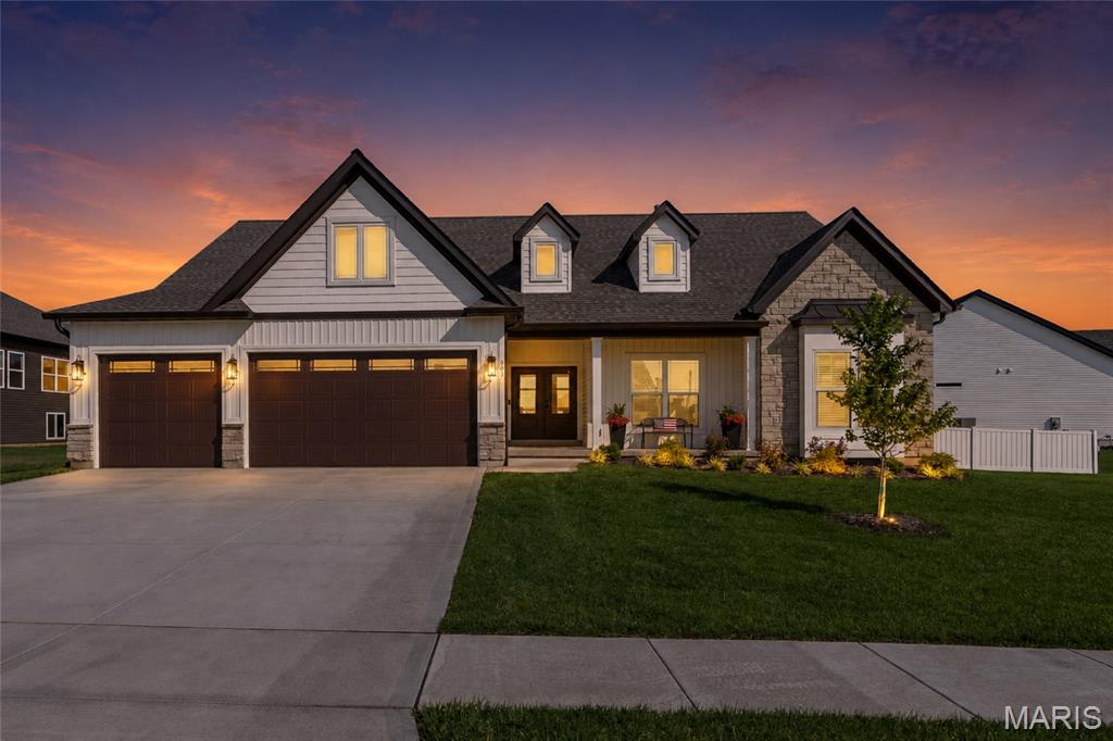 Incredible opportunity! Priced well below today's market value and cost to build new; this exceptional home offers at least $30,000 in instant savings compared to building new. Skip the wait, avoid rising construction costs, and move right into a home loaded with premium upgrades and thoughtful custom features.

Why wait to build when you can have the upgrades and extras now? Located in the beautiful Orchard Grove Subdivision, this barely one-year-old modified Kensington model offers everything the display home has—and more! From the striking double front doors to the thoughtful custom modifications throughout, this home was designed to impress. Upgrades include a 2-foot rear bump-out for added living space, an oversized garage with 4 extra feet of depth, 8' garage doors, and an extra-wide 9' single garage door, plus a 6' x 18' extension connecting the garage to the spacious 18' x 16' covered patio.

Inside, you'll love the soaring 10' ceilings throughout the main living areas and 9' ceilings in the bedrooms and baths. The dream kitchen is loaded with upgrades including stunning Cambria quartz countertops, staggered-height cabinetry, GE Profile appliances, double wall ovens, drawer microwave, farmhouse sink, and an oversized butterfly island with seating for six. The impressive walk-in pantry is a standout feature with convenient countertop-height outlets for added functionality.

The oversized covered patio is the perfect extension of your living space, featuring a ceiling fan and overlooking the fully fenced yard with lawn irrigation to keep your grass lush and green all season long. The spacious primary suite offers a luxurious retreat with a double bowl vanity, huge walk-in shower with dual shower heads, and generous walk-in closet. Two additional bedrooms and a full bath complete the main floor.

The unfinished lower level offers endless possibilities with an egress window and full bath rough-in, ready for your personal touch. Loaded with upgrades and designed with quality throughout, this home checks every box and then some!