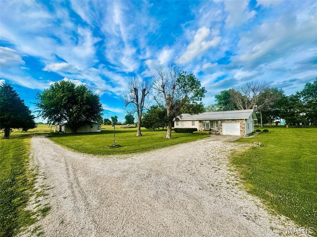 The perfect 3 bed 2 bath 2,400+sqft countryside home sitting on over an acre of land on the outskirts of town! If you can think it, this property has it; full finished basement, non-conforming 4th bedroom downstairs, lower-level kitchenette, large detached garage for additional parking/hobby space, covered concrete back porch & ample space in a peaceful setting. All seen kitchen appliances to convey with home as well as a solid start to your downstairs game room, as the pool table can stay too! If you're even remotely interested, run, don't walk to see this one in person and let's make it yours!