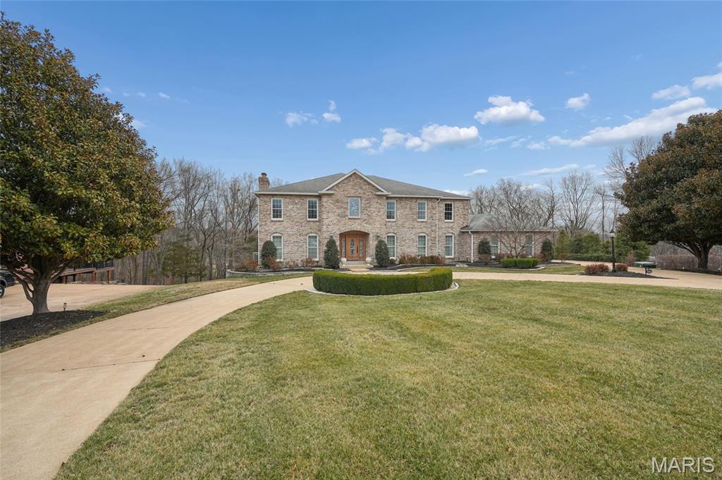 Contingent on the Sale & Closing of Buyer's Property - Continue to Show - Located in the exclusive Sunset Pointe Subdivision, this FIVE bedroom, 3,500+/- sq.ft. Rehnquist Design & Build custom built 2-story is beautifully situated on a wooded 2.26+/- ACRE LOT in one of Sunset Hills’ most sought-after communities. This all-brick beauty with circular drive reflects quality construction and attention to detail throughout. Rich hardwood floors flow through the light-filled Living Room/Office and Dining Room with crown molding, anchored by a two-story foyer with custom mosaic design tile from Italy. The Family Room with pocket doors from the Dining Room is complimented by many windows, a gas fireplace, wet bar with granite counters, sink and wine rack and French doors to the covered deck with ceiling fans. The Callier & Thompson updated kitchen serves as the centerpiece with cherry cabinetry with trim, under cabinet lighting, granite countertops and tile backsplash. The large center island boasts seating, an induction cooktop, beverage/wine refrigerator and lots of extra cabinets. You’ll also find double ovens, two drawer-style dishwashers, a warming drawer, double-bowl sink with hot water dispenser, a HUGE pantry, appliance garage and planning area. The Breakfast Room is spacious with French doors leading to the Florida Room with its own remote controlled mini split system for heating and cooling, ceiling fan AND a heated tile floor. Upstairs, the Primary Suite includes a spacious walk-in closet, ensuite bath with custom mosaic design tile from Italy, dual sinks with storage tower and under cabinet refrigerator, soaking tub, custom tile shower with seat, an abundance of beautiful cabinetry and French Door (with screen door) access to the expansive (750+ sq. ft. on two levels) rear deck with ceiling fans and recessed lighting. The upstairs hallway with hardwood flooring leads to FOUR additional bedrooms (one with deck access), new carpet, stylish lighting and a full updated bath and provides flexibility for guests, a home office, family living or turn bedroom FIVE into your dream closet. Additional features include a main-level laundry with utility sink and half bath, partially finished walkout basement with surround sound, kitchenette, Full Bath, Office/Craft Room/Extra sleeping area and plenty of storage. Lower level French doors lead to the 1,200+ sq. ft. covered deck with recessed lighting and party patio area with built-in firepit and gazebo with lights overlooking the wooded rear yard. Zoned HVAC (2021), two humidifiers, 74 gallon hot water heater, 816 sq. ft. 3-car garage with cabinety, epoxy flooring, utility sink and keypad entry, sprinkler system, fountain by circle drive, alarm system, timers for exterior lights, six panel doors, glass block windows, lots of recessed lighting, new carpet, fresh paint and additional basement storage accessible from outside.  This one-of-a-kind property is built for entertaining and conveniently located in the award winning Lindbergh School district near major highways, shopping, dining, schools, and parks, while offering privacy and a peaceful residential setting.