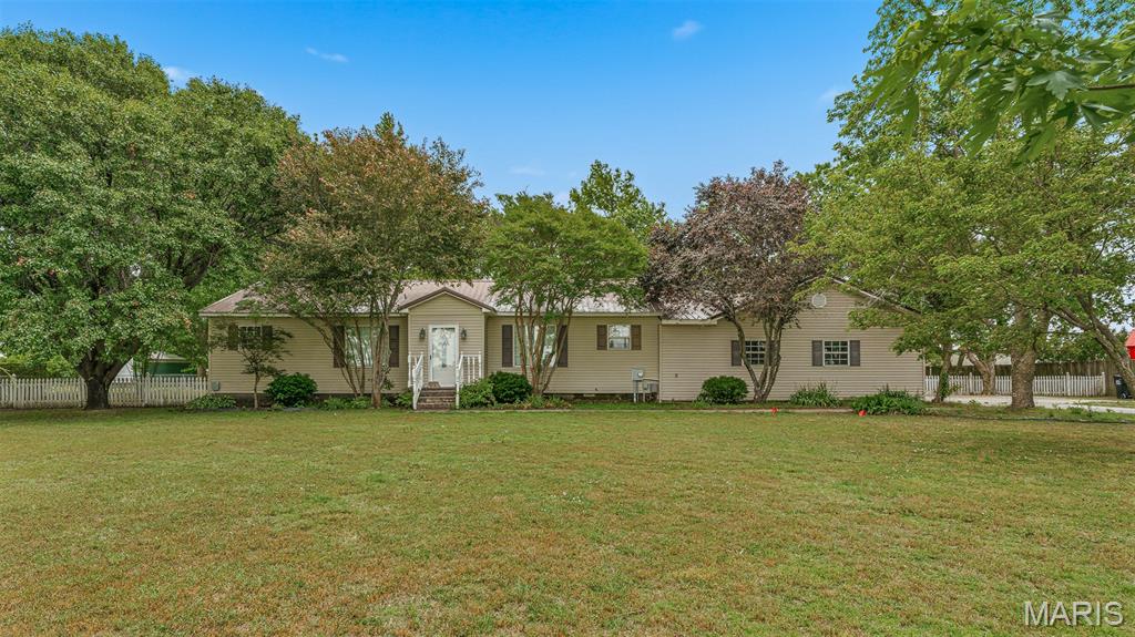 Country living on the edge of town!! This 3-bedroom 1.5-bathroom home is located on one acre of land! The interior updates include newer flooring, new water heater, freshly painted kitchen & more!! The acre of land includes gorgeous landscaping, peaceful country views & mature trees right on the property. The 27X24 workshop is a huge bonus! With electricity & bay doors, the possibilities are endless for this workshop! Call today to schedule your in-person tour of this unique property!
