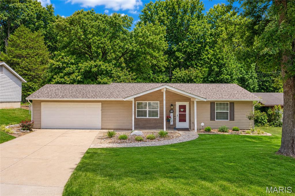Discover this beautifully updated ranch home in O'Fallon, nestled on a peaceful, private Culdesac street. A paved walkway with fresh new landscaping welcomes you to the front door. Inside, this charming home offers just over a thousand square feet of living space with two bedrooms and one and a half beautifully remodeled bathrooms. The kitchen shines with newer stainless steel appliances, a deep double sink, and 42-inch cabinets. Living room and kitchen feature recessed lighting; while bedrooms enjoy ceiling fans, and with new lighting fixtures throughout create a warm, inviting atmosphere. The living room features built-in book shelving surrounding a faux fireplace. Both the front and back doors have storm doors, plus vinyl tilt-in windows throughout and an attic fan for added comfort. Step outside to enjoy a spacious 16 by 20 composite deck overlooking a fully fenced, private backyard that backs to trees for ultimate peace and privacy. You'll also appreciate the newer 10 by 10 outdoor shed for extra storage. Additional highlights include a two-car attached garage, a newer washer and dryer, and a newer hot water heater. All-electric and low maintenance, this home is truly move-in ready.