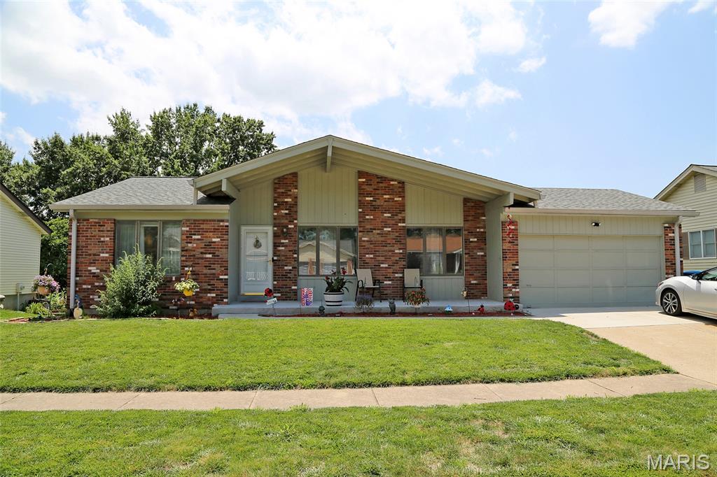 2400 SQ FT, 4BR/3BA WITH WALK-OUT FINISHED BASEMENT! VERY PRIVATE--BACKS TO LOVELY OPEN GROUND + HAZELWOOD ACQUATIC & COMMUNITY CENTER! Spacious covered front porch welcomes you to sit a spell! Enter to foyer with large living room to your right with loads of natural light from 2 oversize windows. Kitchen/Dining Room combo with fireplace is adjacent with slider to deck. Beautiful view from the deck overlooks the level yard that adjoins a large, well cared for greenspace. Looks like a golf course! Three main level bedrooms, including primary bedroom with private bath. Full hall bath rounds out the main level. Walk-out lower level is finished with a family room, rec-room/play area, office, workshop, laundry room with sink, and a FOURTH bedroom with private bath & walk-in closet! Sliders out to covered patio. 2-car attached garage with opener. NEW ROOF in March 2026. NEW HVAC in December 2024. Newer flooring throughout the main level. MUST SEE!