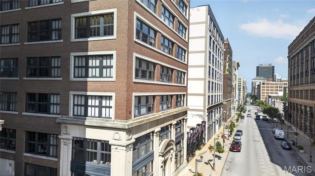 Condo community is VA approved.  Experience authentic urban loft living in this stunning industrial-style condo featuring soaring ceilings, exposed concrete, oversized warehouse windows, and an open-concept floor plan filled with natural light. The spacious kitchen is beautifully appointed with granite countertops, rich wood cabinetry, stainless steel appliances, a large center island with seating, and abundant storage perfect for entertaining. The expansive living and dining areas offer flexible space with impressive city views. The generous primary suite includes oversized windows, a walk-in closet, and an ensuite bath, while an additional powder room adds convenience for guests. In-unit laundry, ample storage, and contemporary finishes complete the home. Ideally located in the heart of the city, you'll enjoy easy access to restaurants, shopping, entertainment, and everything downtown living has to offer.