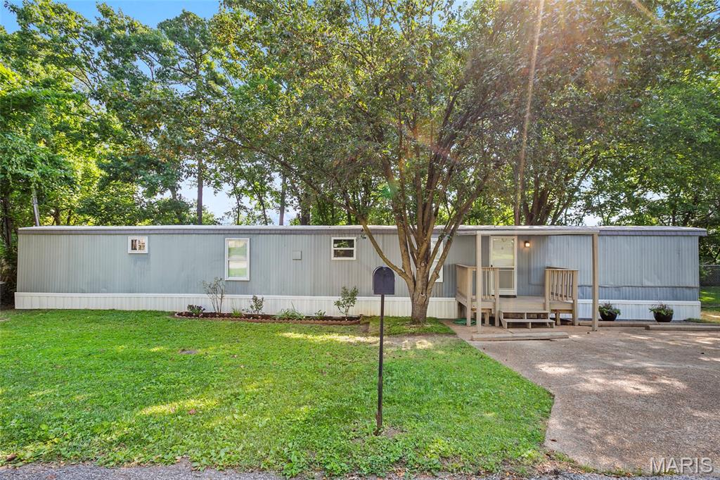 Positioned just a single mile from the shopping and dining hub at Gravois Bluffs, this beautifully refreshed three-bedroom home offers an ideal blend of affordable living and exceptional convenience. Situated on its own private piece of land within a welcoming community park, the property provides a carefree lifestyle with minimal yard care to worry about.

The story of the home shines brightest upon entering the main living space. An open-concept-floor plan seamlessly connects the kitchen and living room, creating an inviting atmosphere that feels both bright and spacious. Freshly painted walls complement the new flooring in the bedrooms and bathroom. Natural light pours in through a full set of brand-new windows, which offer excellent energy efficiency alongside a clean aesthetic.

Every corner has been updated for peace of mind and comfort. The bathroom has been completely refreshed. Practical upgrades extend well beneath the surface, featuring a new furnace, a central air conditioning system updated just two years ago, and a roof that was sealed five years ago.

Outside, your living space expands onto a fantastic back deck. This private retreat is the perfect spot for peaceful morning coffee, evening relaxation, or hosting a weekend barbecue with friends. With the shops, grocery stores, and restaurants of Gravois Bluffs only a three-minute drive away, this move in ready home is a rare opportunity to enjoy updated modern living at a remarkable value.