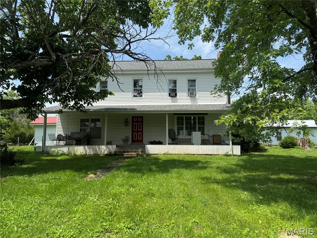 Endless potential on 2.5 acres m/l. Bring your vision and transform this spacious 2,700+ sq.ft. farmhouse, originally built in 1920, into something truly special. Sitting on approx. 2.5 acres, this property offers the charm & character of an older home with good bones & plenty of room to create your dream country retreat or next investment project. Being sold AS IS, this home is a fixer upper and will require significant renovation, but several major updates have already been completed, including a new roof, siding, & water heater that are approx. 5 years old. There is no central air conditioning. Whether you're an investor looking for your next flip, a handyman searching for a rewarding project, or someone wanting acreage with endless possibilities, this property is worth a look. With solid potential and a desirable rural setting, this could be the diamond in the rough you've been waiting for. Cash or conventional financing may be best suited for this property. Schedule your showing today and imagine the possibilities. The deep well needs a pump, but it is on city water.