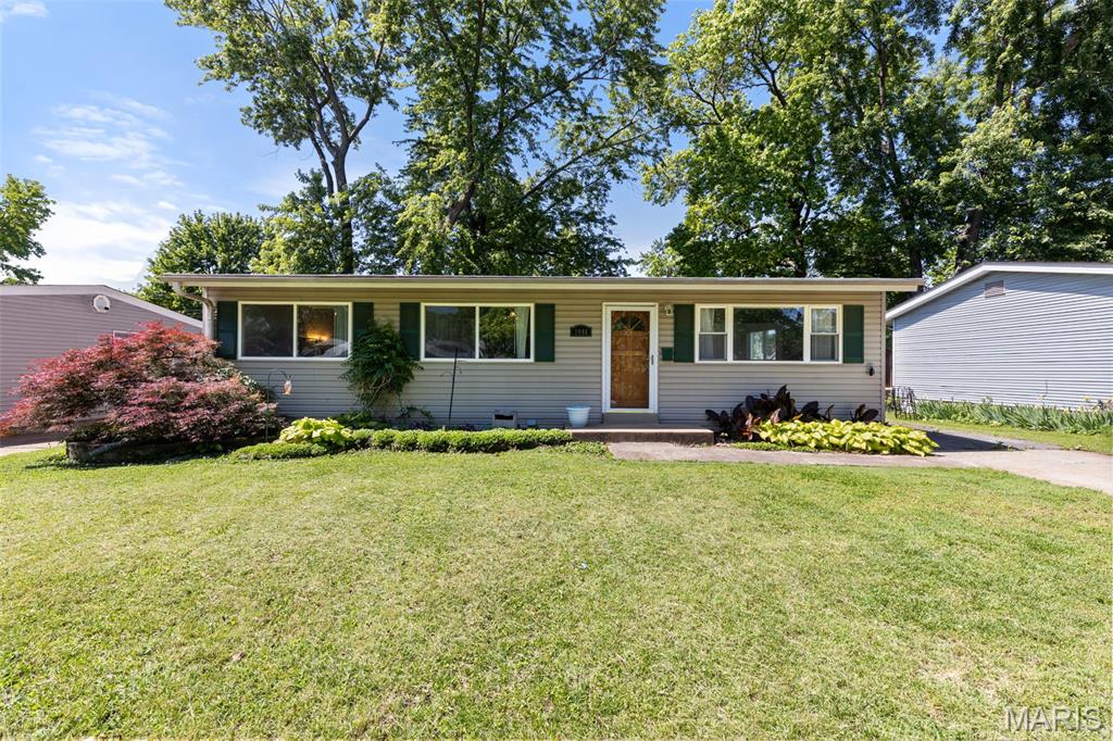 Beautifully updated, this 3-bedroom, 1.5-bath home offers comfort, style, and functionality. Step inside to a bright living room filled with natural light that flows into the dining area and kitchen, creating a great space for everyday living and entertaining. The kitchen features abundant cabinet storage with charming sage green cabinetry extending to the ceiling. Hardwood flooring in the main living areas and durable flooring throughout the bedrooms add warmth and character.

The partially finished lower level provides additional living space with a spacious family room and a bonus sleeping room perfect for guests, a home office, or hobbies. Outside, enjoy the huge fenced backyard with an expansive patio ideal for grilling, gatherings, and outdoor fun. Additional highlights include NEW HVAC in 2025 and roof installed in 2022. Convenient location near shopping, parks, schools, and major highways. Schedule your showing today!