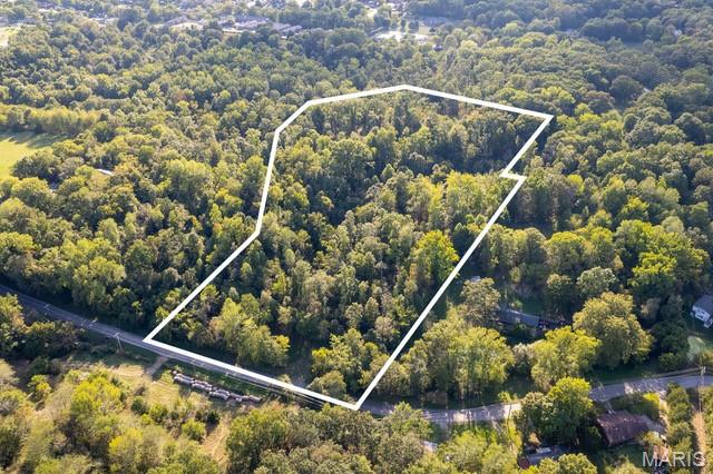 NO DEED RESTRICTIONS
Tract# 3 of this newly split acreage for unrestricted development consists of a 12.88+/- acre timbered building lot with the country feeling of privacy & seclusion.  Located with an entrance off Old Sprigg Street Rd, this rural timbered land tract is just outside of the Cape Girardeau city limits providing an urban setting.  
With paved road access and electric utility accessible at the roadside, this exclusive lot with private recreational acreage is in a natural state and ready for excavation and construction for whatever a Buyer envisions.  With varying topography throughout, there are also potential areas for a pond excavation.
The wildlife is spectacular throughout this raw land.  This property was once labeled as a deer sanctuary and home to an abundance of whitetail deer and much other wildlife that frequent the area.  
This rarely available property with no deed restrictions places you just minutes from the Downtown Cape Girardeau Riverfront business district, and shopping amenities that the city offers.