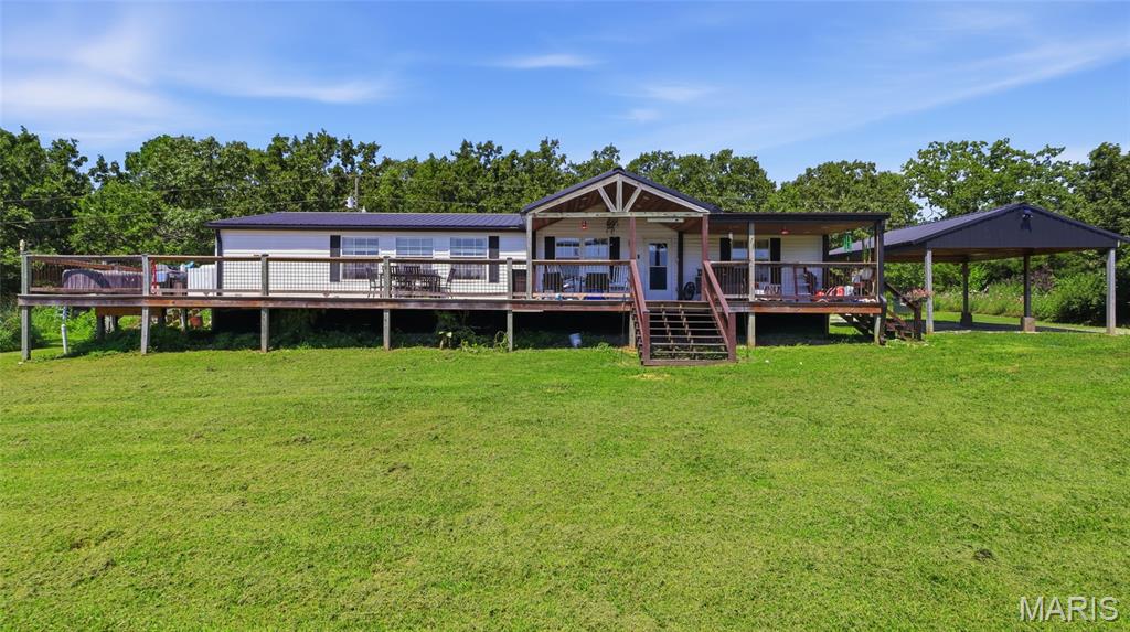 If you've been dreaming of peaceful country living with room to spread out, this beautiful 3-bedroom, 2-bath home on 7 picturesque acres is ready to welcome you home. Mostly open pasture, the property offers stunning countryside views, endless possibilities for hobby farming, horses, gardening, or simply enjoying the wide-open space and breathtaking sunsets right from your own backyard. Inside, you'll love the bright, open floor plan that creates an inviting atmosphere for everyday living and entertaining. The spacious layout allows everyone to stay connected, whether you're preparing meals, gathering with family, or hosting friends. Large windows bring in natural light while showcasing the beautiful scenery that surrounds the home. Outside is where this property truly shines. A newly built 24x24 shop with durable concrete floors and electric service provides the perfect space for projects, equipment, or extra storage. Two generous 12-foot lean-tos—one on each side of the shop—offer additional covered space for tractors, trailers, or recreational vehicles, while the separate car canopy helps keep your vehicles protected year-round. Whether you're looking for a quiet country retreat, space to work on your hobbies, or acreage with room to grow, this property offers the perfect balance of comfort, functionality, and scenic beauty. Opportunities like this don't come along often—schedule your private showing today and experience everything this incredible property has to offer!