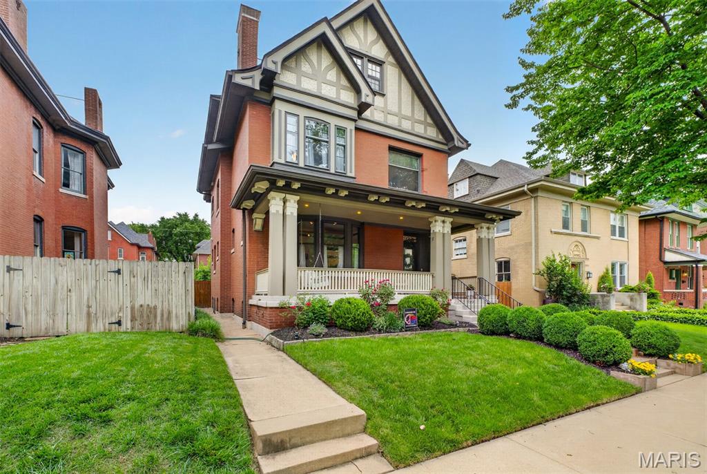 Welcome to Compton Heights, where this beautifully situated home rests on a gated block with a lovely front porch that feels like a quiet refuge in the heart of the city. It is surrounded by one of St. Louis’ most beloved historic neighborhoods, with timeless architecture, tree-lined streets, and a deeply connected community.

This beautifully updated residence blends old-world character with thoughtful modern improvements. A gracious foyer opens to a warm, inviting living room, where afternoon light filters through stained-glass windows above the fireplace, creating a space that feels both elegant and deeply comfortable. Original beamed ceilings, classic corner built-ins, and rich dining room wainscoting speak to the home’s historic craftsmanship, while the updated eat-in kitchen offers everyday functionality with custom cabinetry, dual sinks, high-end stainless-steel appliances, and generous storage.

Set on an extra half lot, the property offers a notably spacious yard, creating exceptional outdoor space, added light, and a rare sense of privacy between neighboring homes. The expansive deck overlooks a fenced backyard with mature shade trees, a raised herb and vegetable garden, and plenty of room for outdoor living, entertaining, gardening, or play space for pets and children alike. A two-car garage adds everyday convenience.

The bedroom layout is equally compelling, including a spacious primary suite with an expanded sitting area, walk-in closet, and a recently remodeled, luxurious primary bathroom. The third floor offers two additional bedrooms and an updated bathroom, creating flexible space for guests, work, recreation, or additional private living quarters.

Compton Heights is known for its architectural beauty, central St. Louis location, and active neighborhood culture, with year-round community events including food truck nights, holiday gatherings, seasonal celebrations, and more. Historic charm, modern comfort, rare outdoor space, and an exceptional neighborhood setting come together beautifully in this Compton Heights home.