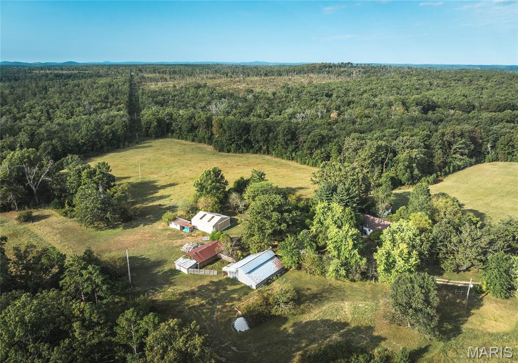 191-Acre Working Farm in Douglas County, MO. With around 55 acres of prime pasture perfect for hay production or grazing, and the mature timber, this property offers plenty of room for farming, hunting, or just enjoying the country life. The land is well-maintained, with several barns, a 3-bay shop, and other outbuildings, set up for livestock, hay, or storing your farm equipment. Whether you’re running cattle, growing hay, or just want to enjoy the wide-open spaces, this place has it all. The main home is a 2-bedroom, 2-bath stucco-style house that’s full of character and craftsmanship. Surrounded by meticulously landscaped gardens and hand-planted trees, the setting is peaceful and park-like—a perfect spot to unwind after a long day. There’s also a detached 1-bed, 1-bath studio apartment—ideal for guests or rental income. This property is a deer and turkey paradise, with the mature timber offering great cover and food sources. Property Features: 55 acres of pasture for hay production and livestock. Beautiful timberland with great deer and turkey hunting. A wet-weather creek running along the southern boundary, attracting wildlife. Multiple barns and outbuildings for storage, hay, and animals. A 3-bay shop for tools, toys, and equipment. Detached studio apartment with a full bath and kitchen. Park-like setting with landscaped grounds and mature trees around the home. Gate will be locked- no drive by's, All equipment & furnishing can be purchased with property.