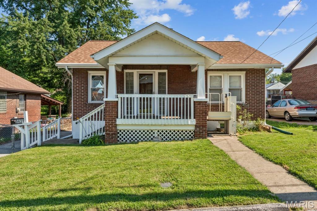 Solid brick bungalow in a convenient St. John location with meaningful updates already completed. This 2-bedroom, 2-bath home offers a practical main-level layout. Newer flooring and double-hung vinyl windows throughout. Major improvements include a new roof in December 2025, complete HVAC system in May 2024, updated plumbing in January 2025, and new electrical panel in April 2026.

The charming eat-in kitchen has a highly functional layout, newer refrigerator and range/oven + includes a built-in hutch corner hutch, adding vintage charm and extra storage. Bathroom has newer vanity and classic basket-weave tile flooring. 

The finished walkout lower level adds valuable flexible space for a family room, hobbies, storage, or workspace, along with a second full bathroom, workshop area, and bonus refrigerator. A finished 19'x12' attic room with closet provides additional usable space not reflected in the main bedroom count. All appliances stay, including washer, dryer, two refrigerators, and range/oven.

Outside, you’ll find a fully fenced backyard, storage shed, ample off-street parking, and a quiet dead-end street setting. Wheelchair lift remains. An affordable, well-maintained home with important updates, flexible spaces, and room to make your own. Great location just 5 minutes to HWY 170 and 10 minutes to the airport and shopping at the Market at Olive.