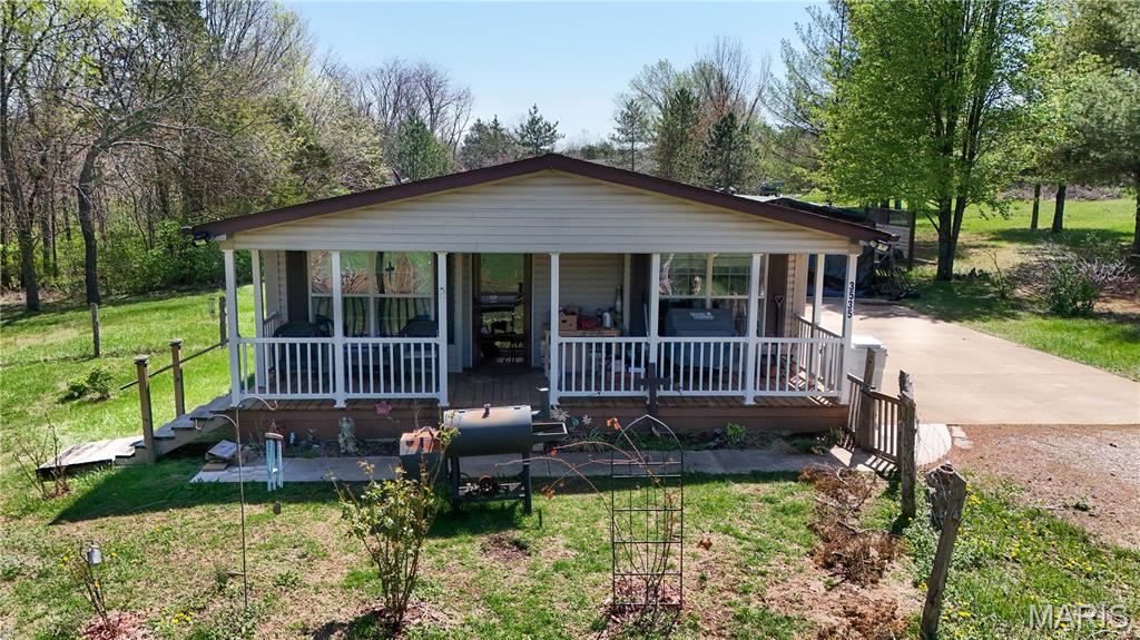 Want a home out of town where you can have peace and quiet? Then this is for you. It is out of town, but not too far from the store or gas station. This quiet area is on 3+ acres, and is open and flat. Bring you animals and enjoy. This home has 3 bedrooms, 2 bath with approx. 1,596 square feet of living space. Kitchen is really nice with custom cabinets and center island where you can eat your breakfast. Also has a separate dining room for company, or family dinners. Living room is nice and cozy with the front door entrance for your dog to go out and enjoy a fenced in yard. Primary bedroom has a full bathroom and a walk in closet.  Two other bedrooms are nice size, or for maybe an office. Laundry room is in the hallway and has a door leading to a huge patio for BBQ's. Carport is also on patio to park your cars underneath when raining or snowing.  This home is on a corner lot and has an open field for your horses or maybe a huge garden.