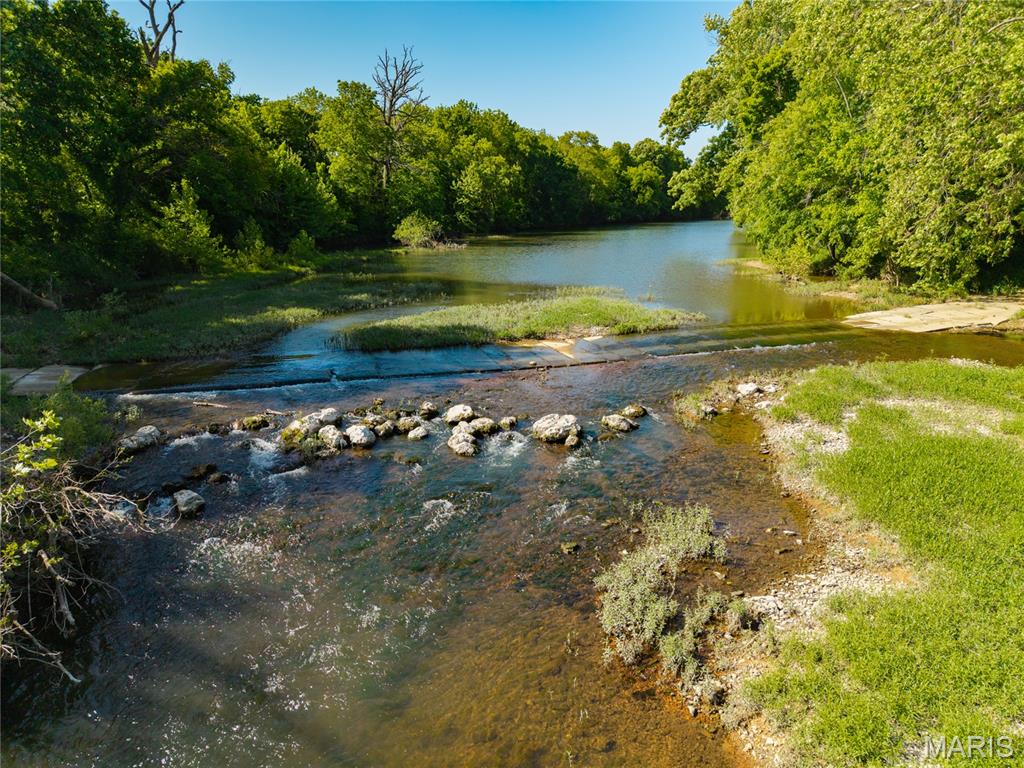 This 270 acre parcel has 1/2 mile of Gasconade river running through it. Providing great fishing and river access there is Indian Creek another year round stream flowing through the property into the Gasconade River. This large 270 acre tract is a hard find it offers awesome Hunting and fishing with the flexibility of raising cattle or livestock of your choice and raising hay as there is 120 acres of fertile bottom soil currently producing close to 600 large round bales per year. This bottom land can be turned into corn, Alfalfa or any hay crop of your choosing it has been producing without the use of fertilizer or spray. The top half of the Farm is accessed across the Gasconade River where the owners have installed a concrete slab for easy crossing. The top part of the farm has a fenced spring fed pond with a concrete waterer. There is a newly drilled well set up completely on solar power that provides water to 3 more concrete waterers. There is a new septic system and Solar to provide power for that off grid cabin of your dreams. There is another well and power along 38 Hwy on the south side of this parcel across the Gasconade River allowing for easy building and well and power on each side of the river. This is truly a special piece of property with the kind of water availability that people are searching for. Don't let this opportunity to own this great piece of the Ozarks pass you by.