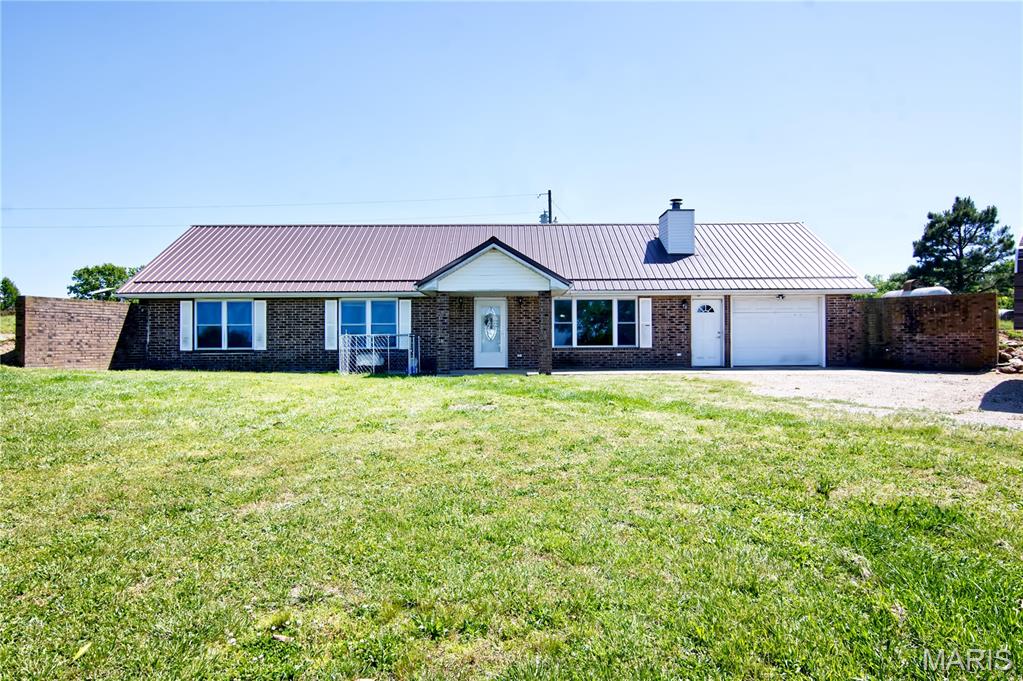 Experience the peace of country living in this charming brick earth home featuring 3 bedrooms and 2 baths. From the moment you step inside, the beautiful brick fireplace creates a warm and inviting focal point in the spacious living room. Designed with comfort and functionality in mind, the generous living area flows seamlessly through a cased opening into the kitchen and dining space, making gatherings and entertaining effortless.
Outside, the property is perfectly suited for hobby farm living, complete with a barn and electric fencing already in place. Whether you’re dreaming of raising animals, starting a small farm, or simply enjoying the open space and quiet surroundings, this property offers the ideal blend of comfort, charm, and country lifestyle.
