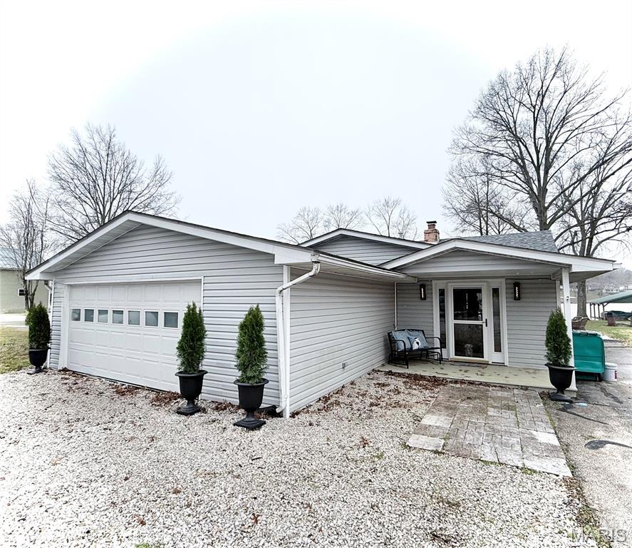 This beautifully remodeled 3 bedroom, 1 bathroom home sits on a flat, waterfront lot with direct lake access, a private boat dock with boat lift. The property includes an asphalt driveway, two-car garage or recreational room, and storage shed. With a brand-new roof, updated electrical and plumbing systems, modern HVAC, and a gas water heater. Updated kitchen with custom granite countertops, rich oak cabinetry, sleek appliances, and thoughtfully chosen hardware and fixtures. Unique engineered wood floors, quality interior doors, cordless top-down/bottom-up cellular shades, and thermal curtains. Whirlpool washer and dryer provide to add convenience. The outdoor spaces is perfect for entertaining features a large back porch with a bar, two concrete patios with pergolas, and breathtaking lake views right from your backyard. Enjoy the 326-acre lake nestled in a welcoming lake community with top-notch amenities.