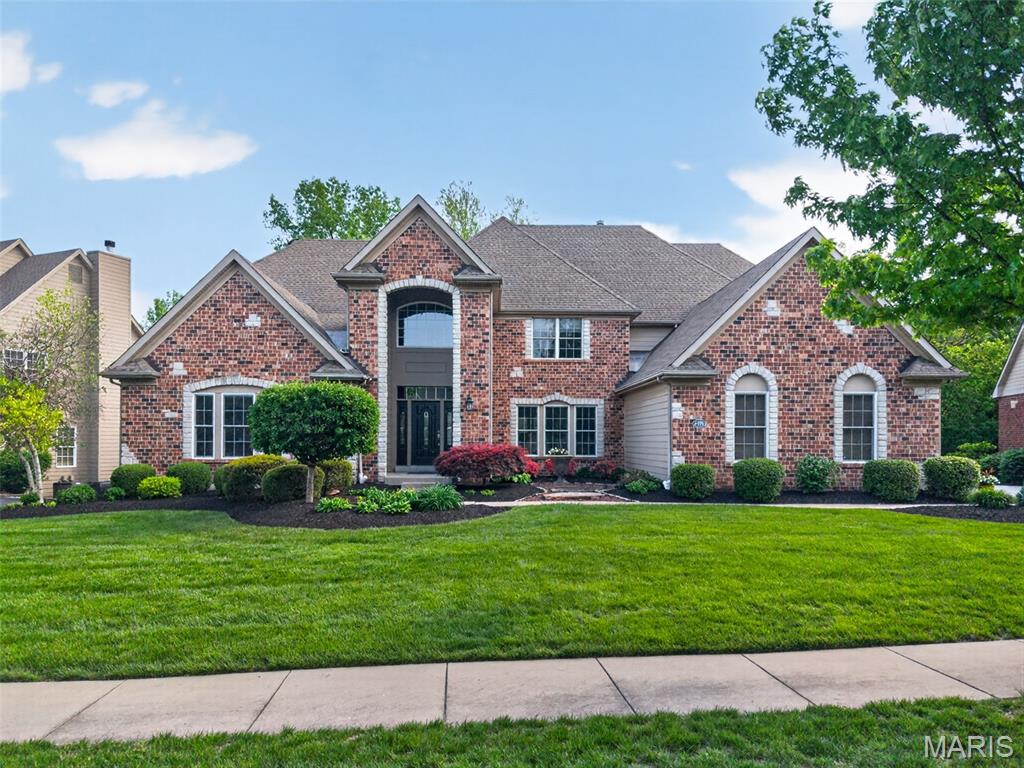 Located within the prestigious gated community of Spring Mill Estates, this extensively updated 1.5-story residence offers a rare combination of refined finishes, thoughtful upgrades, and exceptional indoor-outdoor living—just minutes from Highway 364 and Highway 70.

Positioned on a private, tree-lined lot, the walkout design opens to a resort-caliber backyard retreat featuring a saltwater pool—an ideal setting for both quiet relaxation and elevated entertaining.

A grand two-story foyer creates a striking first impression and leads into the impressive great room, where a dramatic window wall floods the space with natural light. Three gas fireplaces provide warmth and architectural character throughout, while the timeless brick and stone exterior and three-car side-entry garage enhance the home’s curb appeal.

The main-level primary suite is designed as a true retreat, offering generous proportions and a well-appointed en suite with separate soaking tub and shower. The upper level features three additional bedrooms, each with oversized walk-in closets, along with a versatile bonus room ideal for a media room, office, or flex living space.

The home has been thoughtfully refreshed and meticulously maintained, with recent improvements including fresh interior paint across nearly the entire home, a beautifully updated kitchen with refinished cabinetry, modernized hardware, and upgraded appliances, as well as new carpet, updated bathroom flooring, lighting, and fixtures throughout. The primary bathroom has been tastefully enhanced, creating a cohesive and elevated feel.

Significant mechanical investments include three newer HVAC systems, including a climate-controlled garage with added insulation for year-round comfort and efficiency, along with an EV charger. Additional enhancements include updated pool equipment, a whole-home steam humidifier, water softener, and upgraded French doors that seamlessly connect indoor and outdoor living spaces. A Ring security system adds modern convenience and peace of mind.

This is a rare opportunity to own a move-in ready home with meaningful updates in one of the area’s most desirable gated communities—offering a level of comfort, privacy, and lifestyle that is increasingly difficult to find.