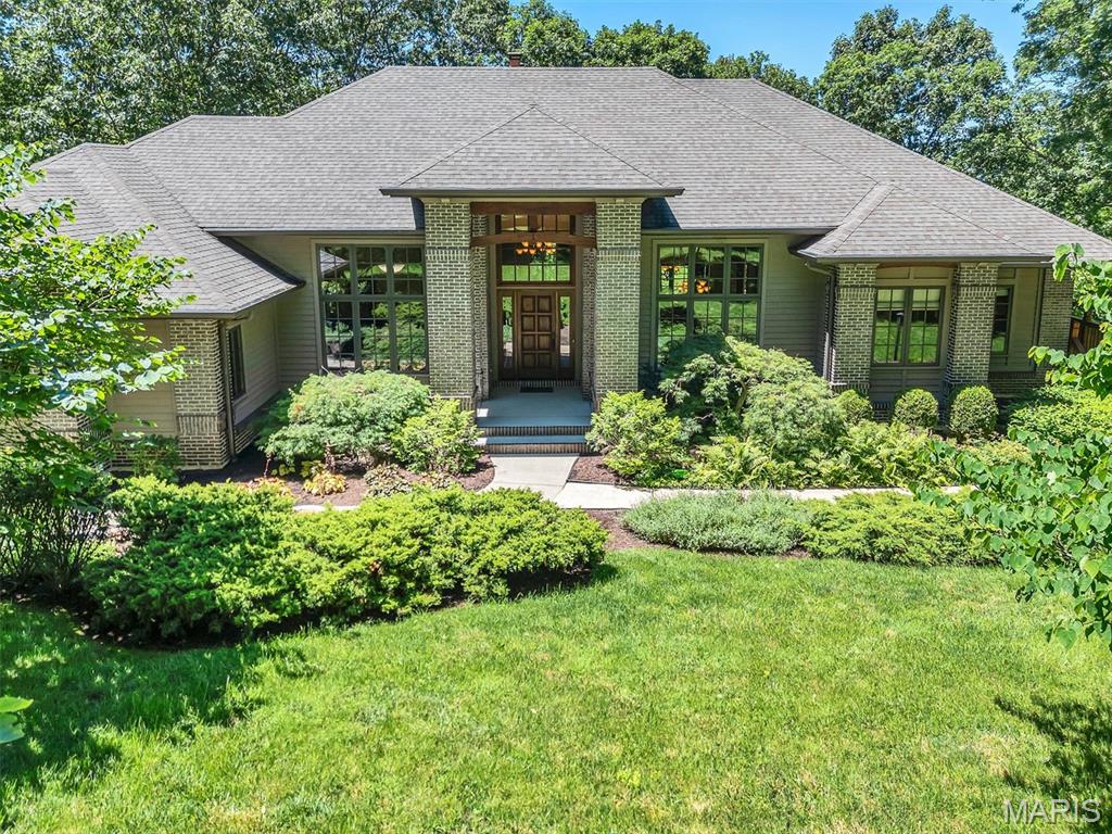 Just Look At This!  Fabulous Custom built Tegethoff Home with 2x6 construction and Cedar and Brick exterior. This outstanding home looks like you are in Colorado. Landscaped and natural, this 4 acre lot has 1 acre  that is fenced. Let's go inside. Beautiful Hickory flooring through most of the home. Owners office/retreat is right at the front door.  The large formal dining directly across. The main living area has custom built windows and has low-e glass. Stunning fireplace with limestone rock, surround sound system, recessed lighting.  The kitchen is just what you would want. Large enough for parties, but still warm and inviting. Note the raw/live edge to the gorgeous granite.  Nice pantry, tons of cabinets. SUB-ZERO refrigerator and Bosch downdraft cooktop. There is a great office off of the kitchen with bookshelves, front facing windows and custom made pocket doors. Homework station? Lady of the House office? How would you use it? The laundry room is really good size. Separate closet houses the hoses for the Central Vacuum. Extra hanging space for your fine washables to dry. Nice light and easy access to the yard. The deck is accessed off the living area. Cedar deck that has a covered area, several sitting areas and an open space to keep the grills/smokers. Make sure youl look out and see the fire pit, chairs and darling bridge. The Master Suite is on the main level and you will discover a marvelous Master Bathroom. There is a large walk-in shower, soaking tub and double sink vanity, plus linen closet. Here is a walk-in closet with organizers and shelves and drawers.  On this side of the house you will find the 3 car garage here. Insulated and drywalled. There is a washing up sink, as well as a central vacuum outlet. Perfect for when you want to wash your car. An extra bump-out space for a work bench is found here, too.  Let's go downstairs, shall we? The stairs take you to the family room. There is a wood-stove that warms the place beautifully in winter. Full length windows and glass door over look the natural backyard. I'm told that many a movie night is enjoyed in this spot. There is a bedroom on both ends of the LL. Each with a large walk-in closet. One large bedroom is an en suite with organizer system in the closet. And another bathroom, while across from the 3rd bedroom, is also services the family room and the GYM. Now this gym is something else. Great flooring, 11' ceiling, plenty of room for your equipment. There is a closet here, but no window.  The walk-out takes you right out to the backyard.  As mentioned before 1 acre close to the house is fenced. The rest of the land is not. If you are a nature lover and like to see the birds & woodland animals, you are going to love this!  This is an immculate home. And the custom touches are superb. No cooky-cutter house here. Beautifully set on the lot. The surrounding homes are all fabulous, as well. Not to be missed for a discerning buyer. You will not see another like this.