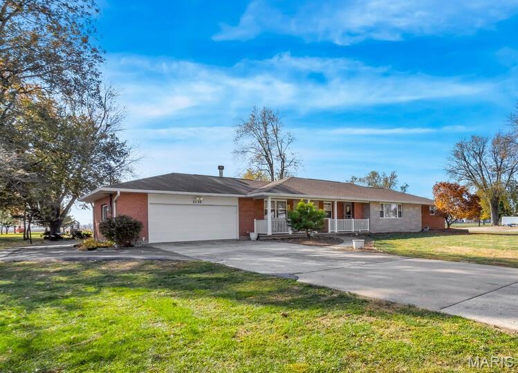 All-brick and built to last, this 4-bedroom, 2-bath ranch sits on a big lot wrapped in mature trees, with an oversized 2-car garage plus a separate workshop/outbuilding for projects, storage, or both.
Inside, the living room centers on a wood-burning fireplace and opens to a formal dining room and a sunny breakfast area. The kitchen is large and fully updated, with a center island, eat-in space, newer appliances, and storage to spare. The primary suite is complete with a private bath and a separate sitting and dressing area for a little extra room to breathe. Three more bedrooms bring generous space for family, guests, or a home office, and a true four-bedroom home.  Enjoy outdoor living on the deck or the covered front porch. Country quiet, with all the St. Charles amenities just minutes away.