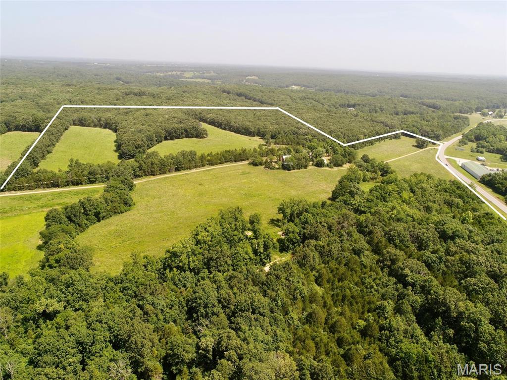 60.7 acres with good road frontage on Hwy 28 between Owensville and Rosebud. Property features a strong mix of open and wooded ground ideal for building, recreation, or hobby farming, plus a creek running through the acreage. Includes a 4-bedroom farmhouse (1935) with multiple outbuildings; no value assigned to the home or structures and they are sold as-is. Parcel will receive its own tax ID after closing. Convenient location offering rural privacy with quick access to nearby towns. A versatile tract with excellent potential.