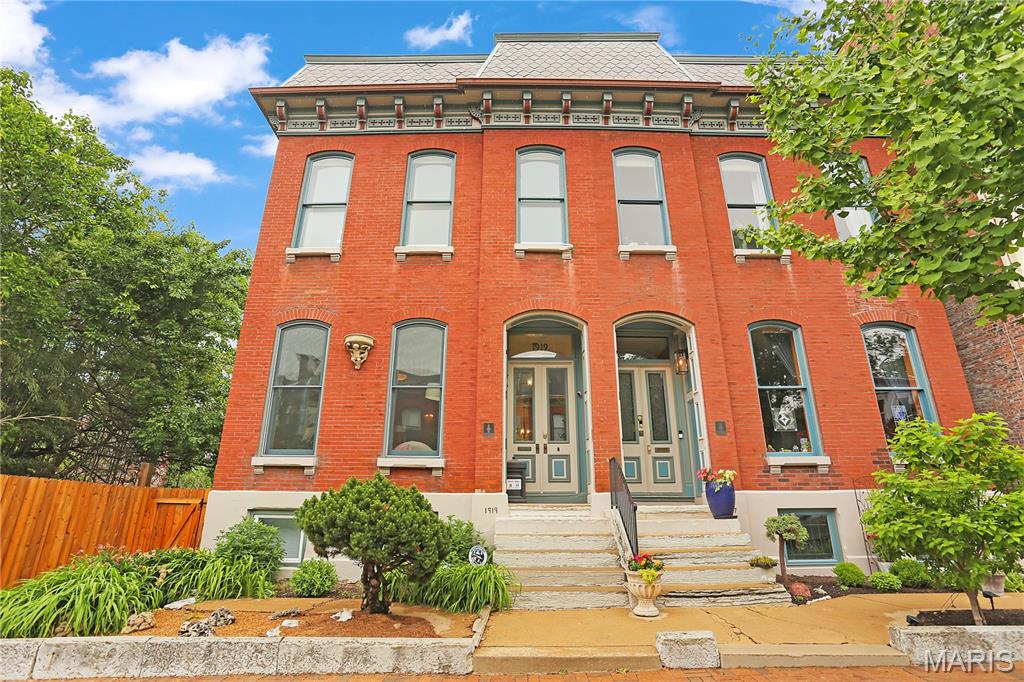 Welcome to a rare find in Historic Lafayette Square. Located on a sought after street known for it's beautiful "Painted Ladies", this home has been meticulously cared for and improved with all newer roofs, zoned HVAC systems, upgraded kitchen and newer decks. A rarer find is the 2 car attached heated & cooled tandem garage and 1 additional space off the alley. Something unheard of in this neighborhood. The main floor features a large living room and dining room separated by working pocket doors. Hardwood floors are found throughout the main and 2nd levels. Soaring ceilings and historic moldings are everywhere. The main floor rear area is a huge kitchen with tons of cabinets open to the family room which had an 8' tall sliding door onto the large deck for entertaining. Beyond the deck is another large storage room, perfect to over-winter plants and pots. The spacious primary suite features, a dressing room with two huge closets, a laundry and separate bath ensuite. There are two additional bedrooms and a large hall full bath on this floor. The 3rd floor is one large attic space for storage and systems. The lower level at grade is the garage, large mudroom / laundry area, utilities room, and then a large open rec room with a 2nd kitchen area and a large full bath. There is a bonus room currently used as a guest bedroom. Having a 2nd exterior entrance, this area would make a terrific suite for inter-generational living. A narrow side yard makes for additional outdoor living space or a convenient space for the pooch to run. Enjoy the Summer Concerts in Lafayette Park, walk to restaurants and bars, and enjoy being 15 mins to everywhere! Convenient to SLU, The Cortex, Mid-town, and downtown. Don't miss this home in your search!