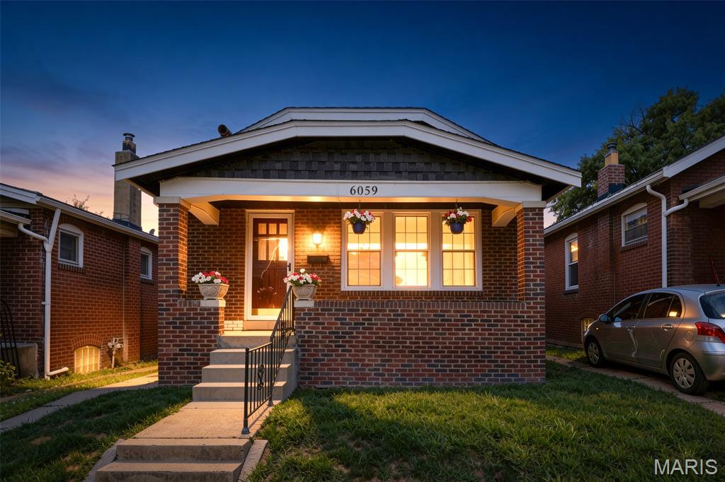 Located in the sought-after Holly Hills area, this home blends historic charm with practical living. Welcome home to this beautifully maintained 2-bedroom, 1-bath all-brick gem! Brimming with classic character and thoughtful features, this home offers warmth, style, and functionality at every turn. Step inside to discover gorgeous hardwood floors that flow throughout the main living spaces, complemented by elegant archways and stunning stained glass windows that add timeless architectural charm. The inviting living room features a cozy electric fireplace, perfect for relaxing evenings or entertaining guests. The kitchen boasts beautiful granite countertops with a dishwasher in the island. The bathroom has been updated as well. Enjoy your morning coffee or unwind in the bright sunroom, or take in the neighborhood from the covered front porch—ideal for enjoying all seasons. The home also boasts a clean, dry walk-up basement, offering excellent storage or potential for additional living space. Outside, you'll find a cute yard with a garden area and a 2-car detached garage with convenient alley access, providing both security and easy parking. Don’t miss your opportunity to own a piece of this vibrant community—schedule your showing today!