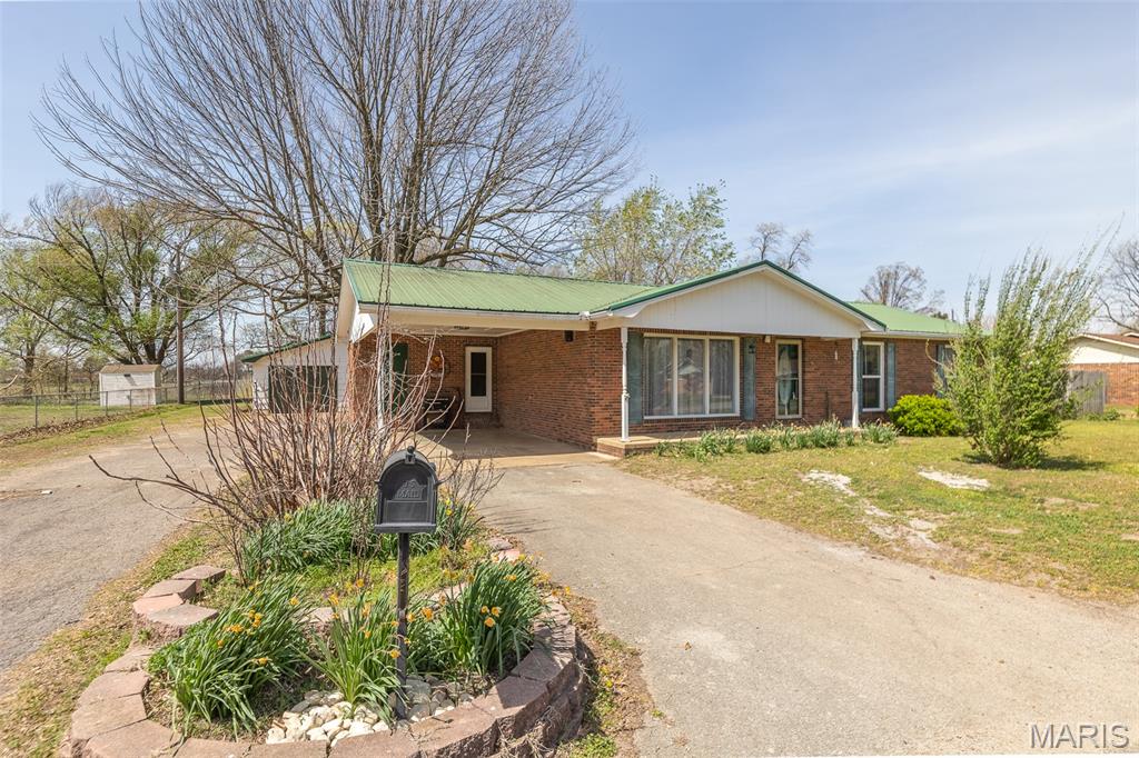 Welcome to this beautifully maintained all-brick home offering over 1,600 square feet of comfortable living space in one of Malden’s most sought-after subdivisions. From the moment you arrive, you’ll appreciate the exceptional curb appeal and inviting presence this property offers. Inside, you’ll find a spacious open floor plan filled with natural light, creating a warm and welcoming atmosphere throughout. The home features 3 bedrooms and 2 full bathrooms, along with a custom kitchen complete with real wood cabinetry, providing both functionality and timeless style. Additional highlights include energy-efficient windows, a newer metal roof, and a move-in ready condition that makes this home truly stand out. Step outside to enjoy a large privacy-fenced backyard, perfect for relaxing, entertaining, or accommodating pets. The property also offers a covered carport and a detached two-car garage/shop, ideal for extra storage, hobbies, or workspace needs. This home is expected to qualify for all government loan programs and offers an incredible combination of value, condition, and location. A must-see opportunity you won’t want to miss.