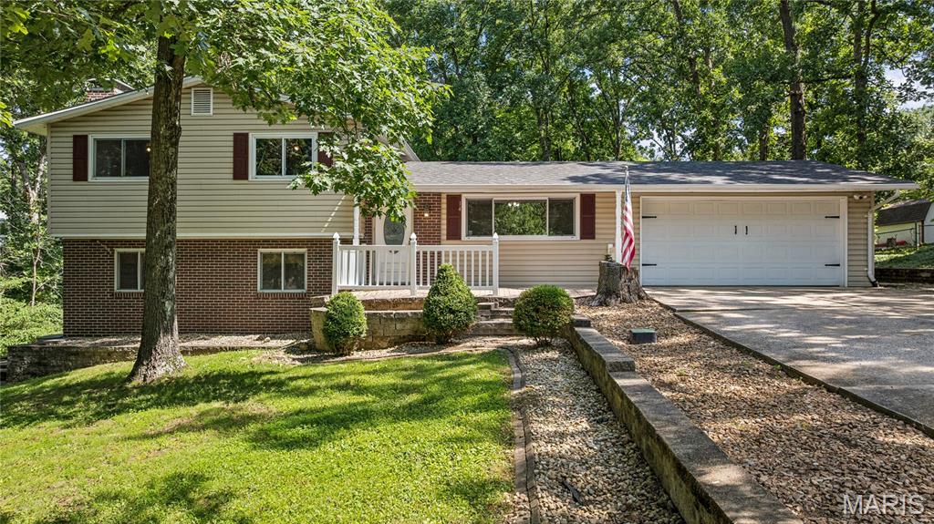 Beautifully updated split-level home nestled on a private, wooded lot with over a half-acre of peaceful outdoor space. This 3-bedroom, 2-bath home offers a warm and inviting layout featuring hardwood floors, spacious bedrooms, and a cozy lower-level family room with a stunning white brick wood-burning fireplace and exposed beams.
The bright eat-in kitchen opens to a large sunroom filled with natural light and scenic backyard views year-round. Step outside to enjoy the expansive composite deck, fenced backyard, and park-like setting surrounded by mature trees — perfect for relaxing or entertaining.
Additional highlights include an oversized 2-car garage, updated paint and flooring, generous storage, and a quiet setting that feels tucked away while still being conveniently located. This move-in ready home combines comfort, charm, and outdoor beauty all in one!