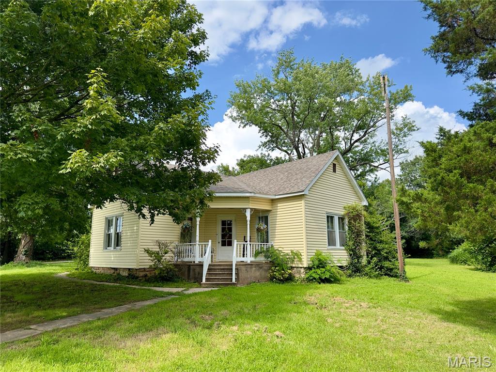 Step into this charming 2 bedroom 1 bath home with features such as archways, classic lighting fixtures, attached 2 car garage, and bonus room. A must see to appreciate all the beauty. The house is being sold as is but don't let that fool you, the roof was replaced in 2025, HVAC in the past 6 years, new siding, and an remodeled kitchen. This property is located in town and has a massive 1.4 acres that includes a barn and additional building allowing all kinds of possibilities. Come check out this one of a kind opportunity and let your imagination run wild.