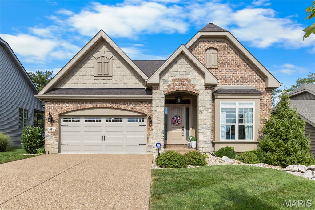 Welcome to this Luxurious Ranch style home where you will be greeted with over 2,500 sqft of living space. You'll be welcomed with tall ceilings and gleaming hardwood floors upon entering the foyer. The amazing kitchen is a chefs dream with a double oven and a large island, soft close custom cabinets and stone countertops. The cozy living room features a stone gas fireplace, perfect for those fall evenings. The main floor master bedroom is perfection with a large master bathroom and walk in closet. The maintenance free back deck is the perfect retreat whether starting or finishing your day, this home features one of the best lots in the neighborhood. The finished basement features a bedroom and full bathroom, great for entertaining or overnight guests.  Located near all the best amenities Chesterfield has to offer.