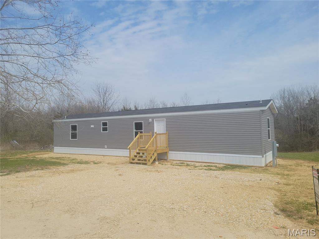 Affordable living right outside of town! New 3 bed, 2 bath mobile home on nearly a half acre just minutes from Moscow Mills and US-61. Home features a large master bedroom big enough to easily fit a King sized bed, a walk in closet and full en-suite bathroom. Galley style kitchen has an abundance of counter and cabinet space and comes complete with refrigerator, dishwasher, stove/oven and microwave. Living room has enough space for all of the essentials such as a sectional and recliners and is centrally located in the home, making it perfect for hosting guests. The property backs to trees giving ample privacy in the back yard and lays great, giving the perfect place to build a shop or put a pool. Home is connected to public water and community sewer so you don't have to worry about upkeep on a well or septic.