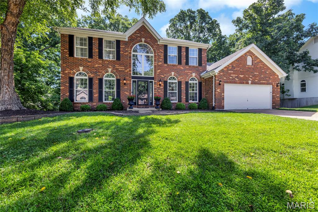 Welcome to 724 Oaksdale Summit Court. This beautifully updated 1.5 story residence offers over 4,000 square feet of pristine living - including 4 bedrooms and 4.5 baths, nestled on a private 0.56 acre lot. A stately brick facade invites you into the dramatic two story foyer with modern lighting and gleaming wood floors, flowing into the formal dining room with arched windows and a statement chandelier. The light-filled great room has soaring ceilings and showcases a woodburning fireplace with marble surround, expansive two story windows and access to the deck. Designed for everyday living and entertaining, the kitchen features a generous center island with breakfast bar, stone countertops, stainless appliances and hood, contemporary farmhouse sink, pantry and adjoining breakfast room. The main floor primary suite is a peaceful retreat and offers two walk-in closets and opens to the luxurious ensuite bath with dual vanities, soaking tub and separate shower. The main floor laundry and powder room add convenience. Upstairs, find three spacious bedrooms - one with a private ensuite bath and the other two connected via a jack and jill bath. The finished, walkout lower level offers a kitchenette with refrigerator, wall oven, microwave, dishwasher and sink, a generous family room with built-ins, a versatile bonus/sleeping room with egress window (easily converted to a true 5th bedroom), a full bath and ample storage. Recent updates include newer HVAC and carpeting, upgraded lighting, fresh interior paint and more. Relax on the tiered deck overlooking the serene, wooded backyard. Prime Wildwood locale with easy access to shopping, amenities and within award-winning Rockwood School District boundaries!