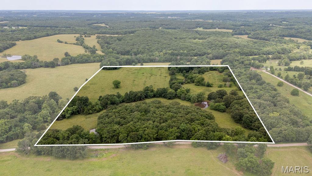 30 +\- acre property located in the Northeast corner of Polk County, Missouri, very close to Pomme de Terre Lake. With convenient access off Highway 65, the land is roughly 65% pasture and 35% mixed hardwood timber, featuring a wet weather creek, two ponds, and perimeter fencing. This versatile property would make an excellent build site, hobby farm, or additional pasture for cattle. With road frontage and easy access, this property combines seclusion, convenience and recreation. This is a must see!