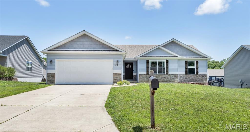 Welcome to this beautifully maintained ranch home in the desirable Cuivre Valley subdivision! Built in 2016, this 3-bedroom, 2.5-bath home offers the perfect blend of modern comfort, functional living space, and inviting design. Vaulted ceilings and an open-concept layout create a bright, spacious atmosphere throughout the main level, making it ideal for both everyday living and entertaining.

The heart of the home is the well-appointed kitchen, featuring stainless steel appliances, custom cabinetry, pantry storage, and an oversized solid-surface center island that flows seamlessly into the dining and living areas. Just off the dining room, sliding glass doors lead to a large deck overlooking the backyard—perfect for hosting gatherings, grilling, or simply relaxing outdoors.

The spacious primary suite offers a walk-in closet and a private en-suite bath complete with a double vanity, separate shower, and soaking tub. Two additional bedrooms and a full bath provide plenty of space for family, guests, or a home office.

The partially finished walk-out lower level expands your living options with a large recreation room, family room, half bath, and ample storage space. French doors lead to a patio and generously sized backyard, creating additional opportunities for indoor-outdoor living.

Additional features include a 2-car attached garage, main-floor laundry, public utilities, and an annual HOA. Conveniently located near schools, parks, shopping, and easy access to Highway 47, this home combines small-town charm with modern convenience.

Don't miss your chance to own this move-in-ready home with nearly 2,800 square feet of finished living space, versatile entertaining areas, and a sought-after location in Troy!