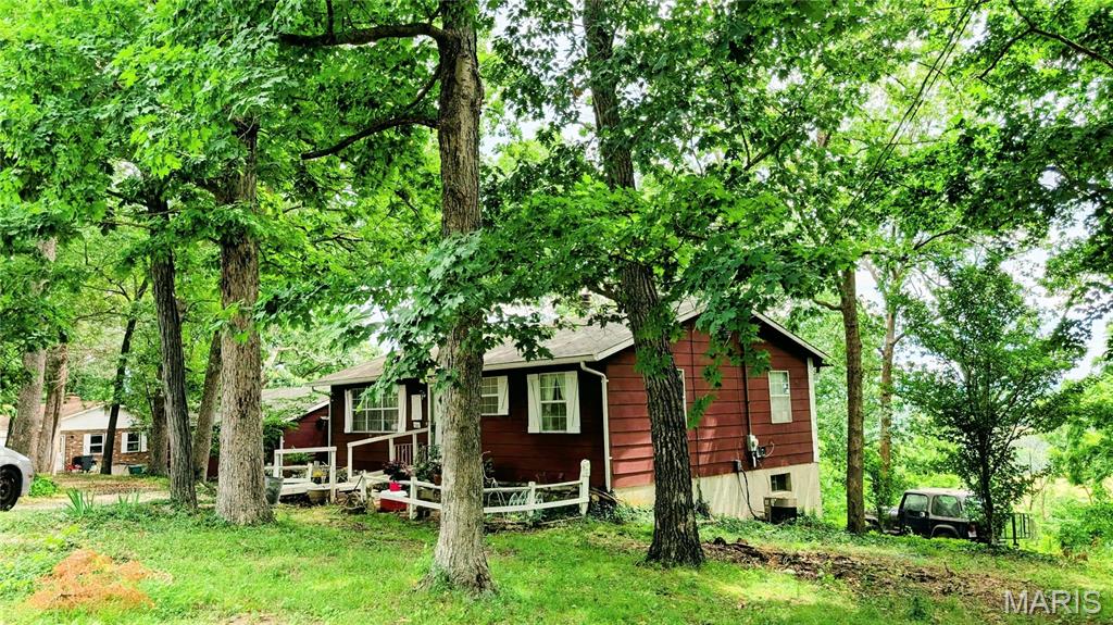 Be charmed & astounded by the view!  This home sits on an acre in the quiet & stately (aptly named) "Riverview Estates" subdivision.  The View from these bluffs... fields & farmhouses against the backdrop of the foot hills to the Ozarks.  Homes is 1184 sq FT With a FULL Bsmt & 2 Car Garage!  The Larger of the bedrooms has a view of the valley. Basement is finished and has kitchenette, bathroom and it also walks out so would be fantastic for in-law quarters.  There is also a Sunroom that connects from the garage to the kitchen. This Sturdy home has recently had new Heater installed. Septic has been tested, finishes are original, she is ready for your updating.    SHOWINGS START SATURDAY 6/20 == MAKE YOUR APPOINTMENT SOON!